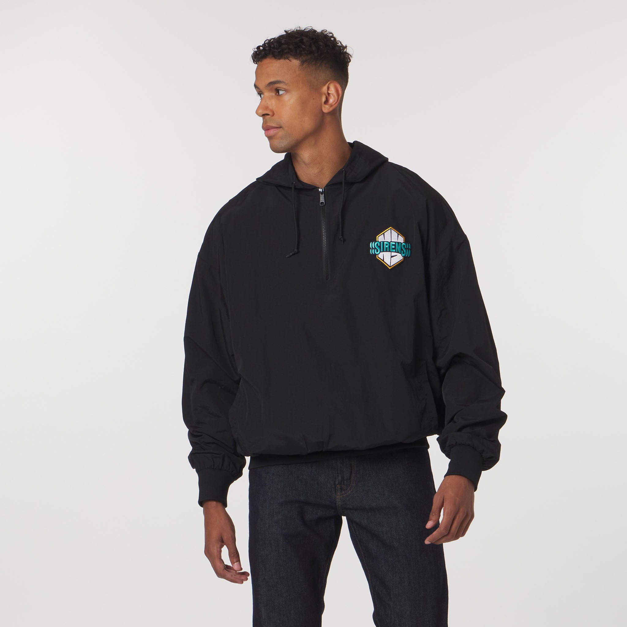 Person wearing a black hoodie with a logo on a white background