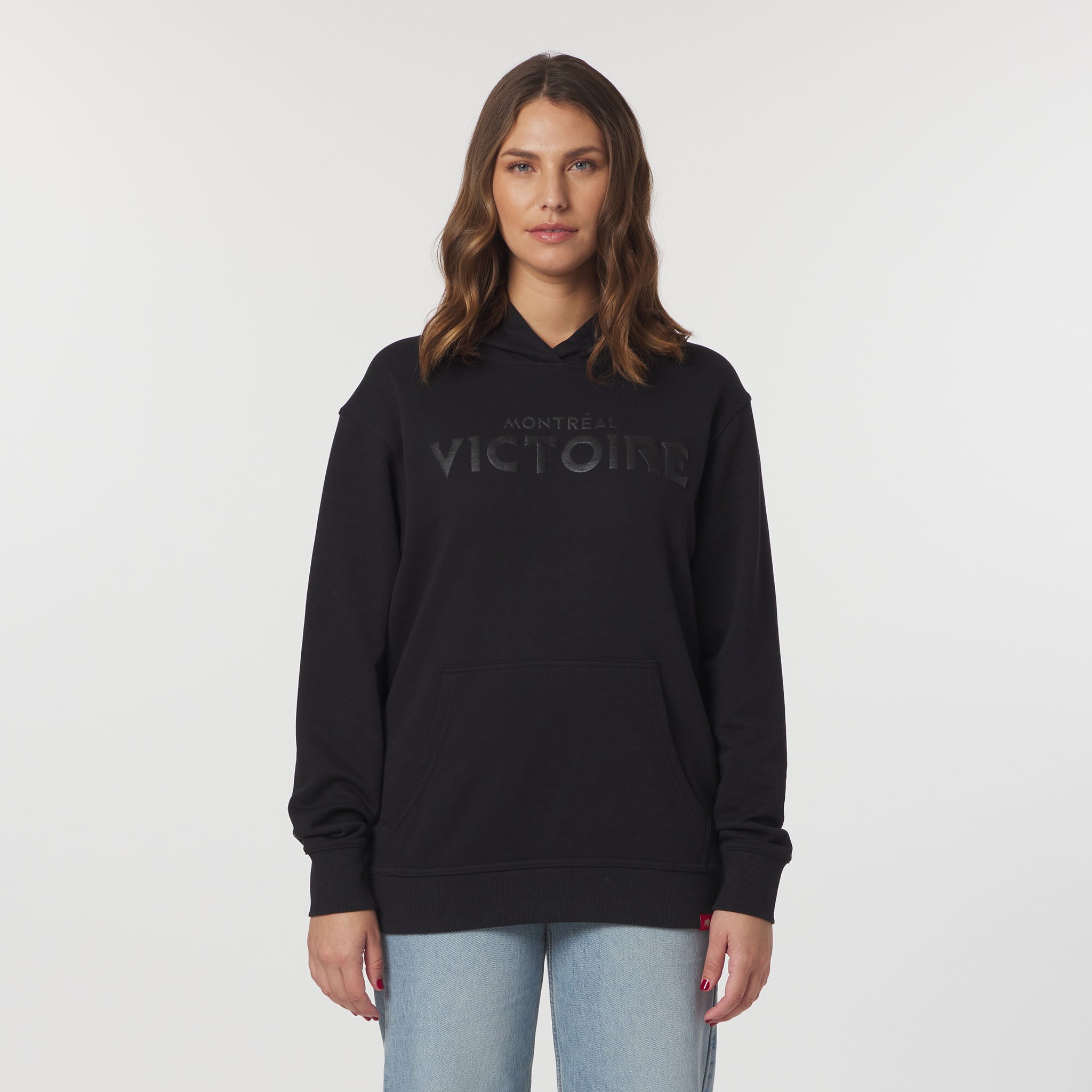Woman wearing a black hoodie with 'Montreal Victory' text on a white background