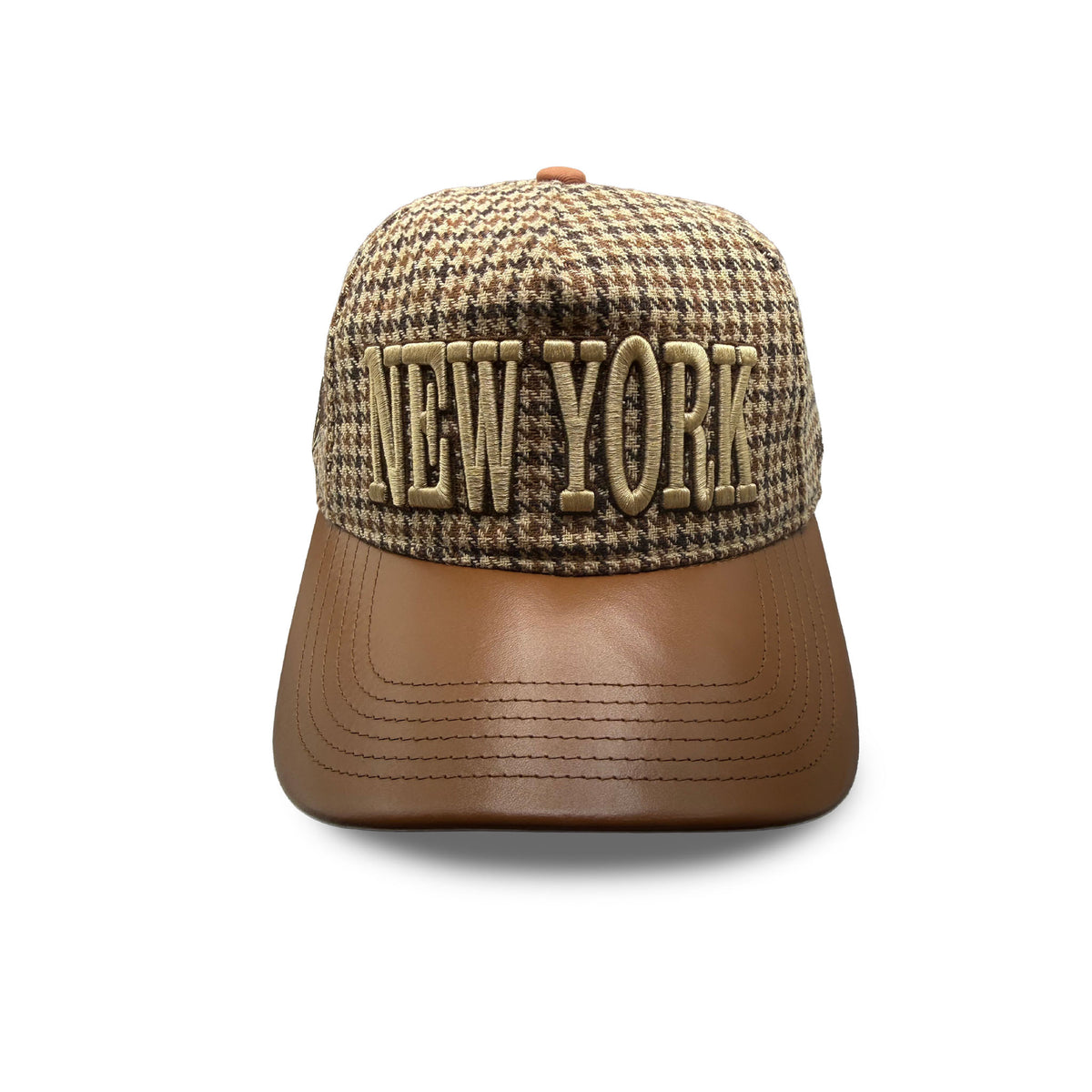 Front of a tan houndstooth hat with a brown leather brim and 'NEW YORK' embroidered in tan. 