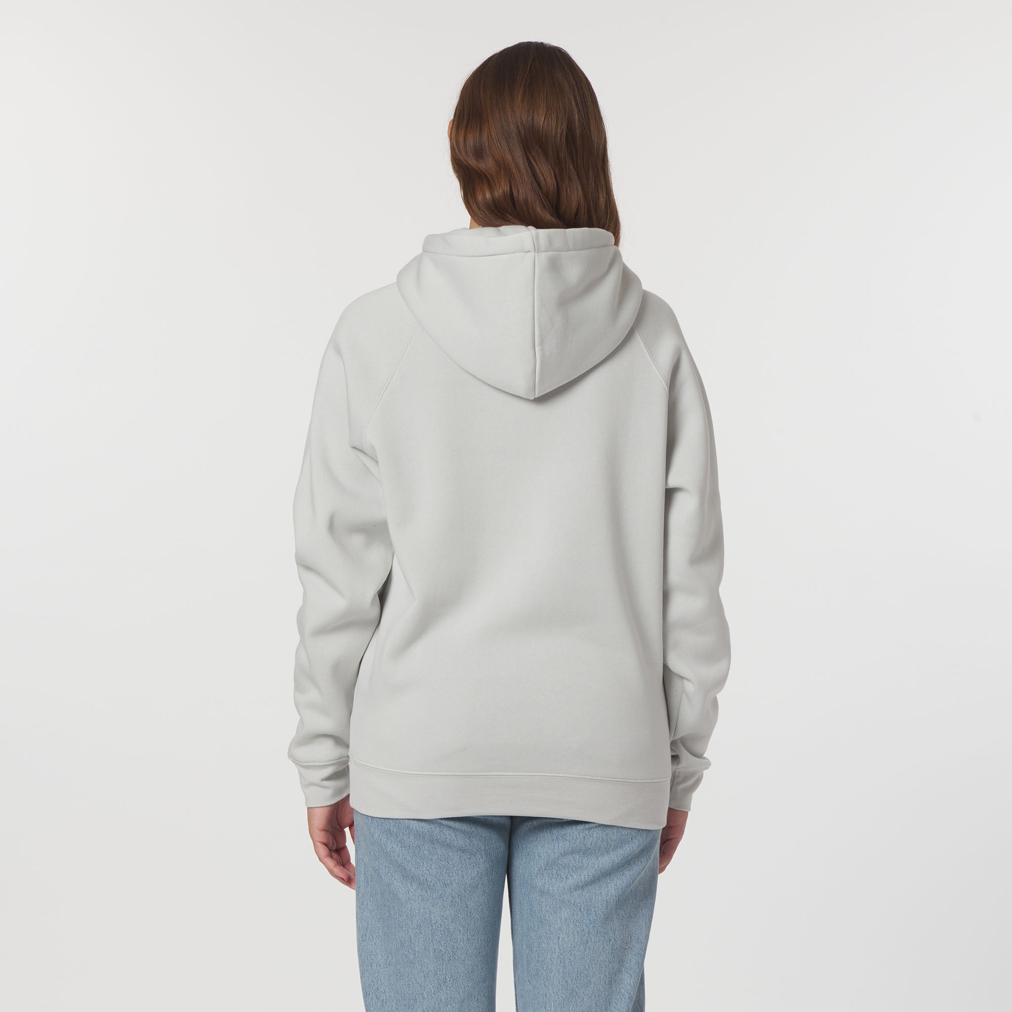 Person wearing a light gray hoodie on a white background