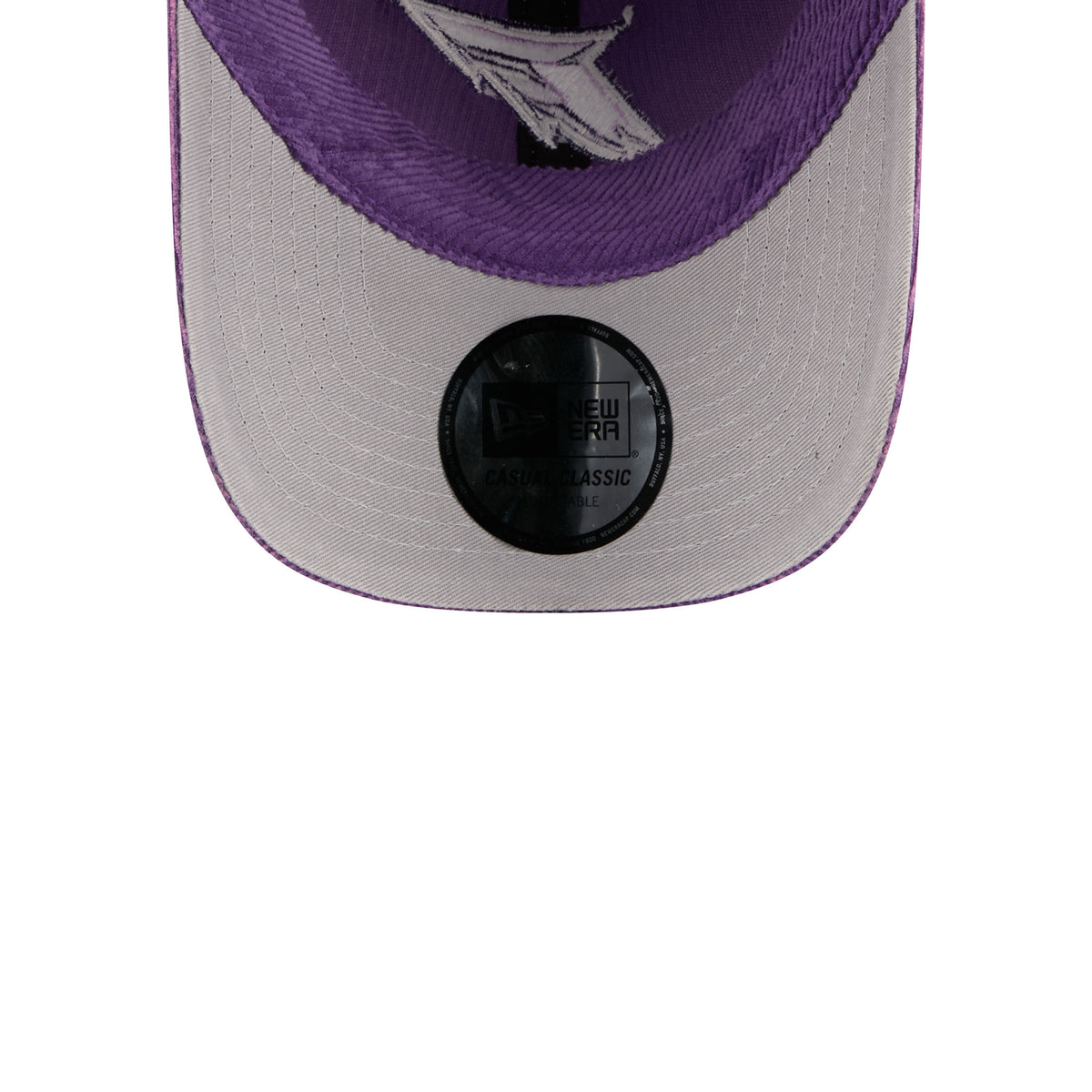 Close-up of the back of a New Era baseball cap in purple and light gray, showing the black size adjustment strap and a white logo on the inner crown.