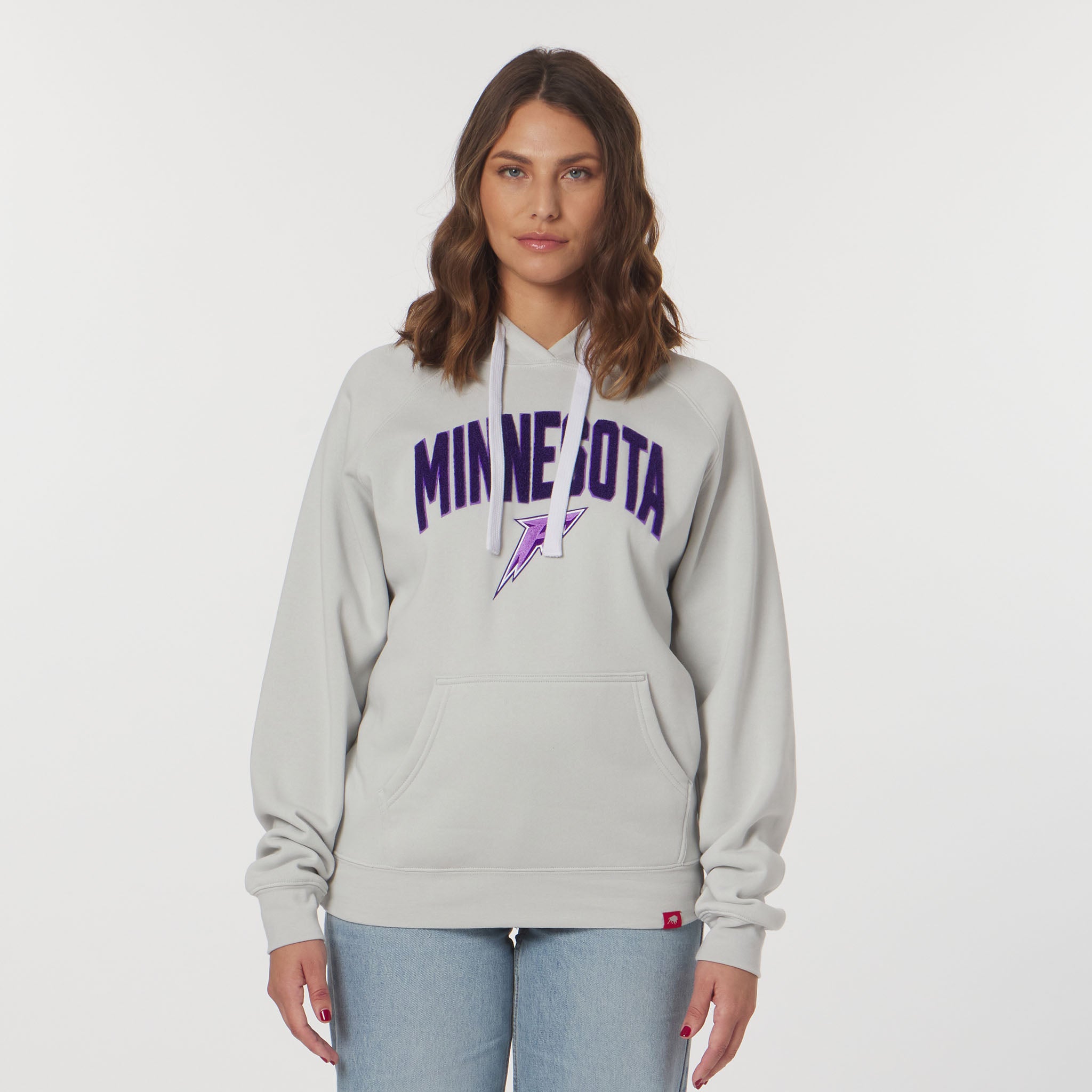 Woman wearing a gray hoodie with 'MINNESOTA' text on a white background
