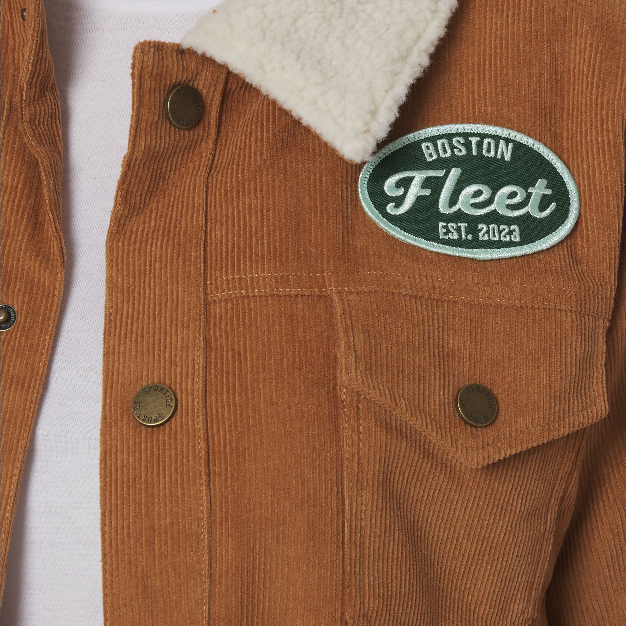 Brown corduroy jacket with 'Boston Fleet' logo on a white background
