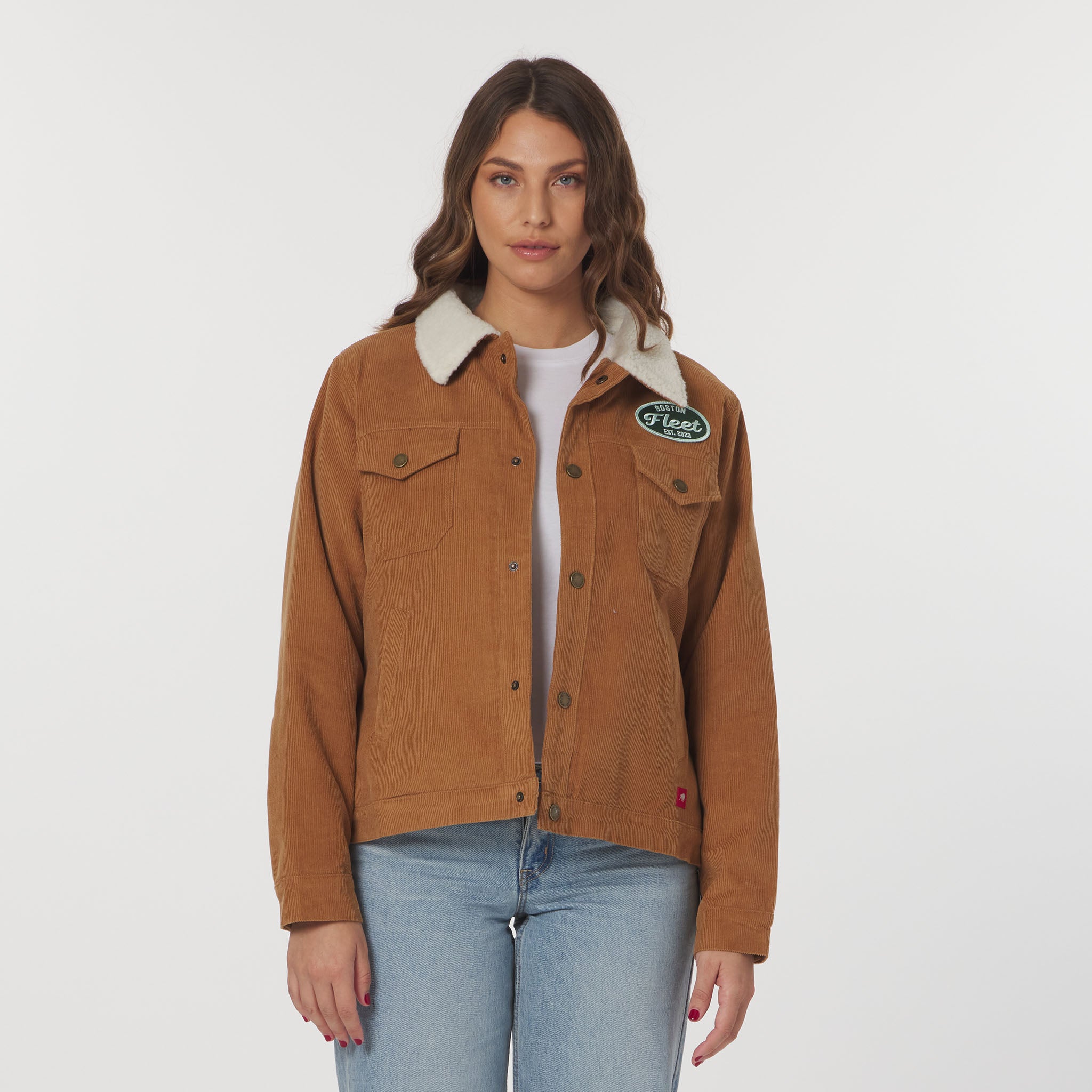 Woman wearing a brown jacket with a brand logo on a white background