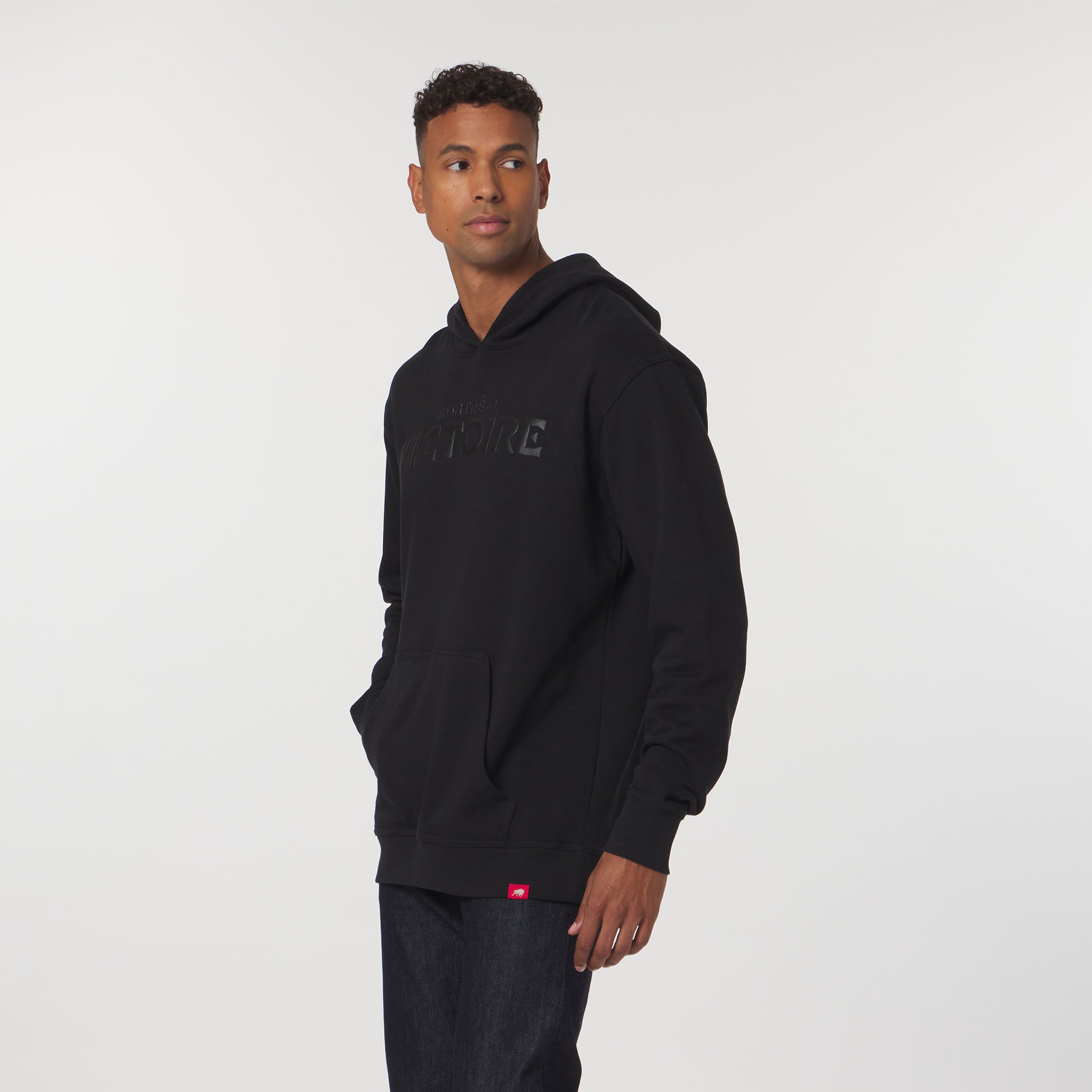 Man wearing a black hoodie with a logo on a white background