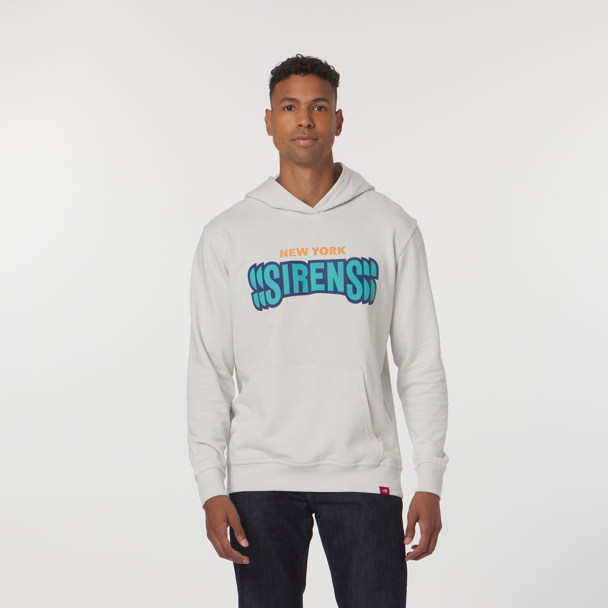 Man wearing a light gray hoodie with colorful text on a white background