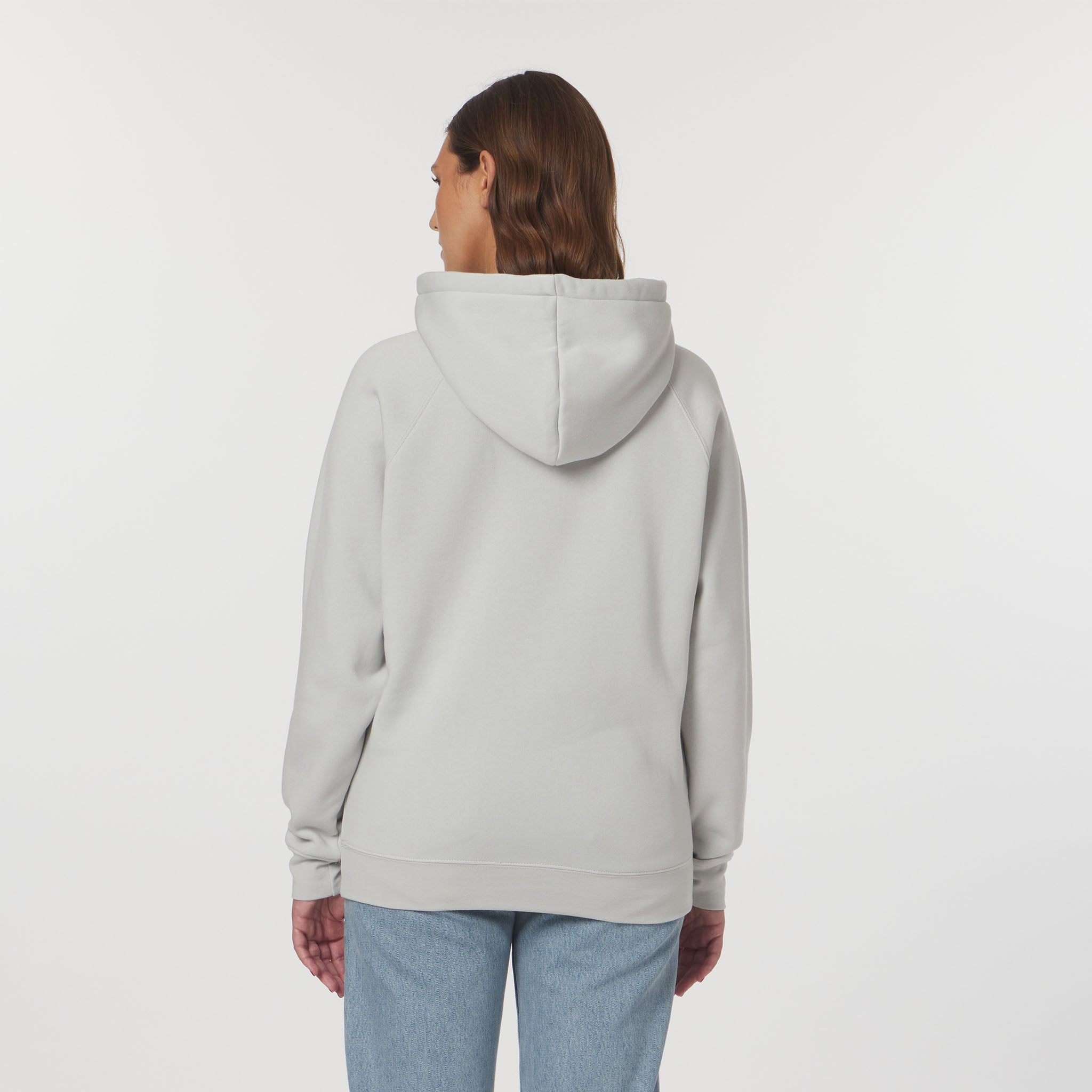 Person wearing a light gray hoodie on a white background