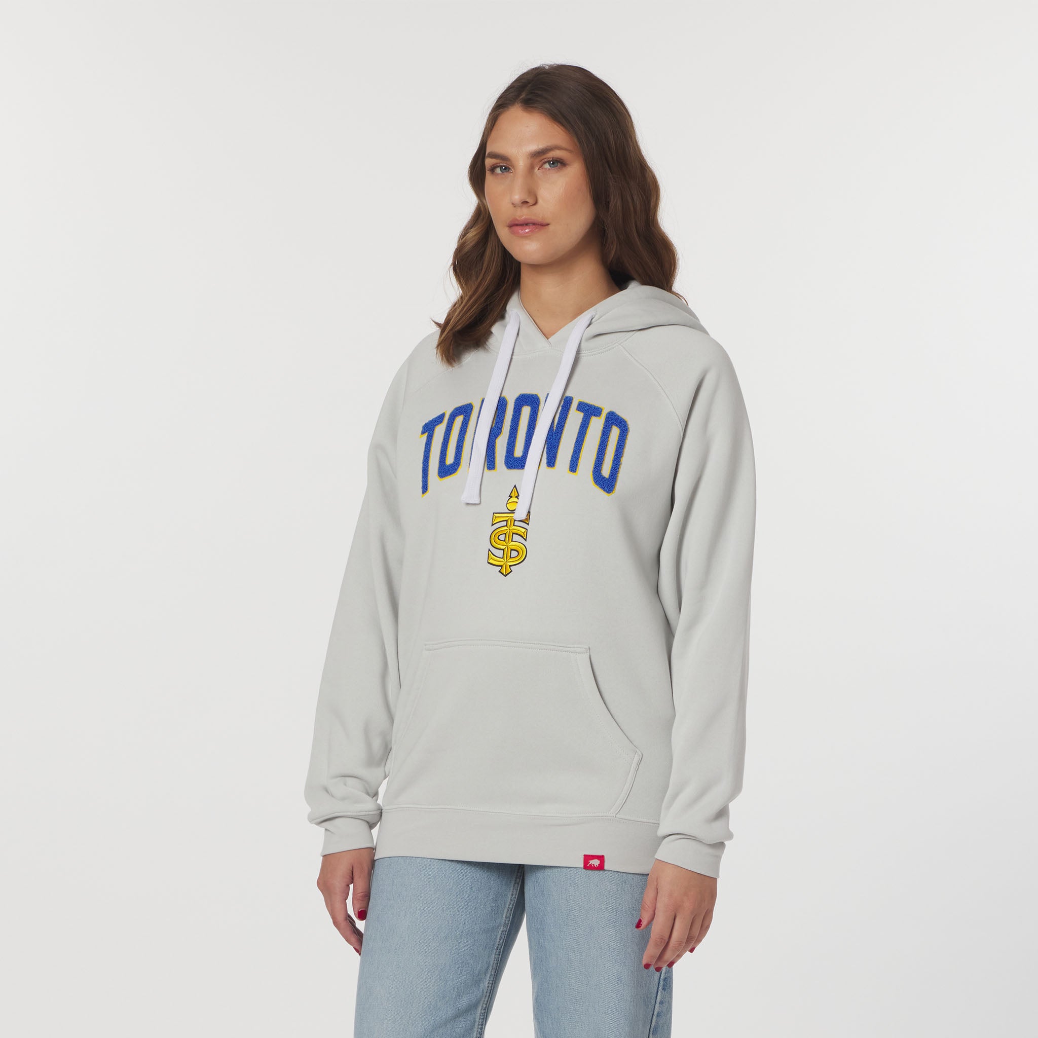 Woman wearing a gray hoodie with 'Toronto' and a dollar sign on a white background