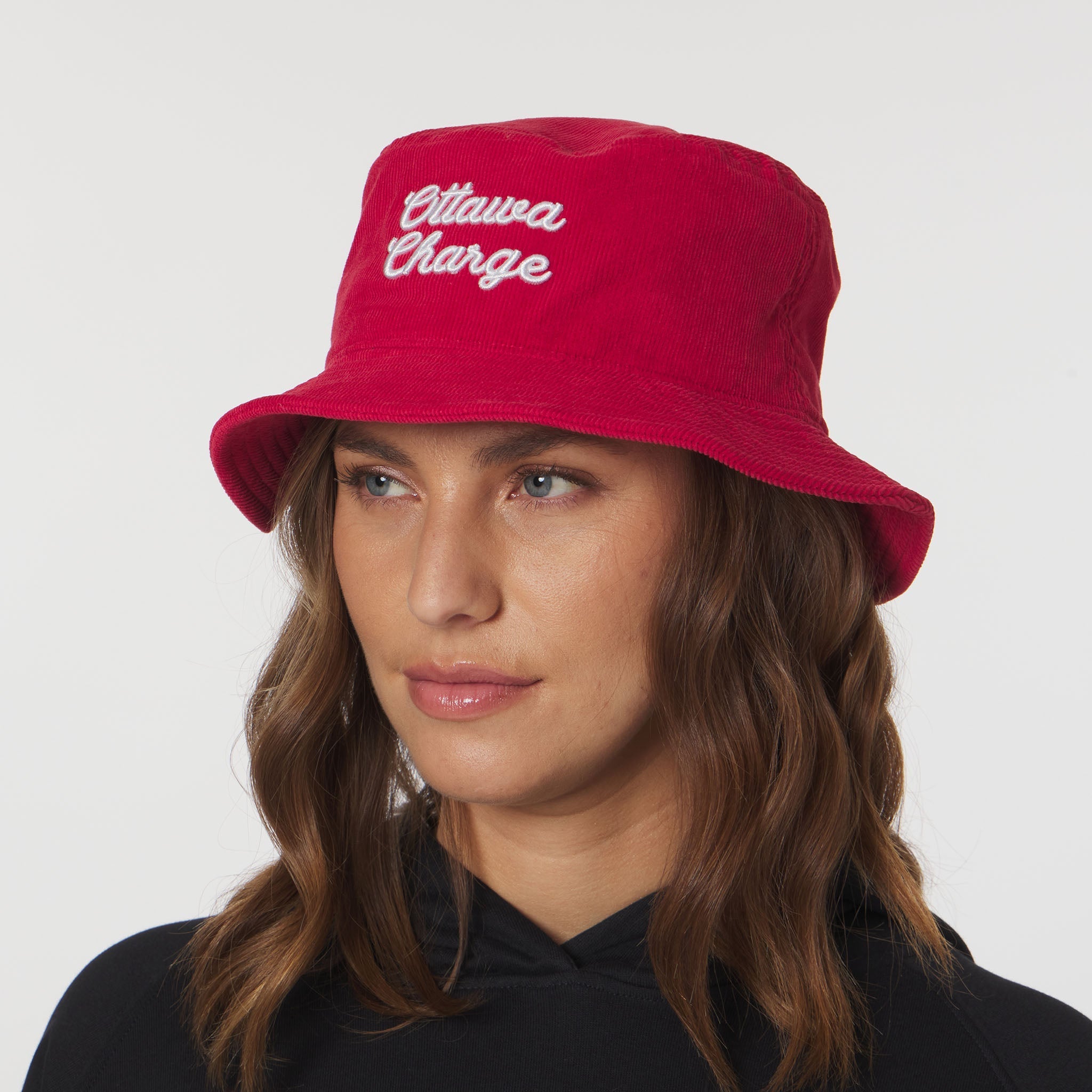 Person wearing a red bucket hat with 'Ottawa Charge' text on a white background