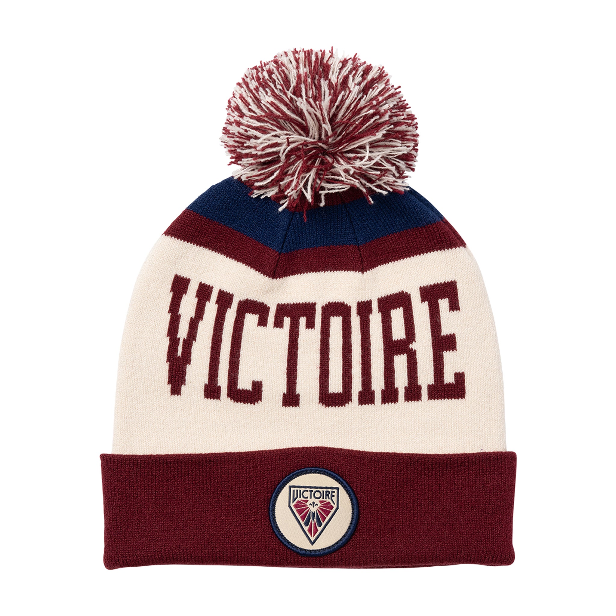 Knitted hat with 'VICTOIRE' text and pom-pom on a white background