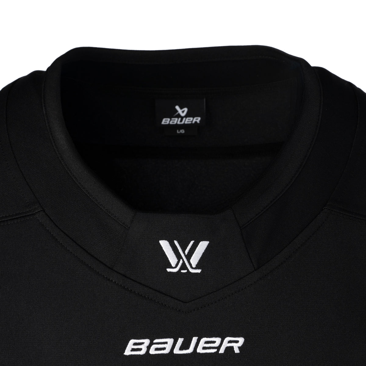 Front of a black jersey with a white PWHL logo is on the front of the collar and a white Bauer logo below it.