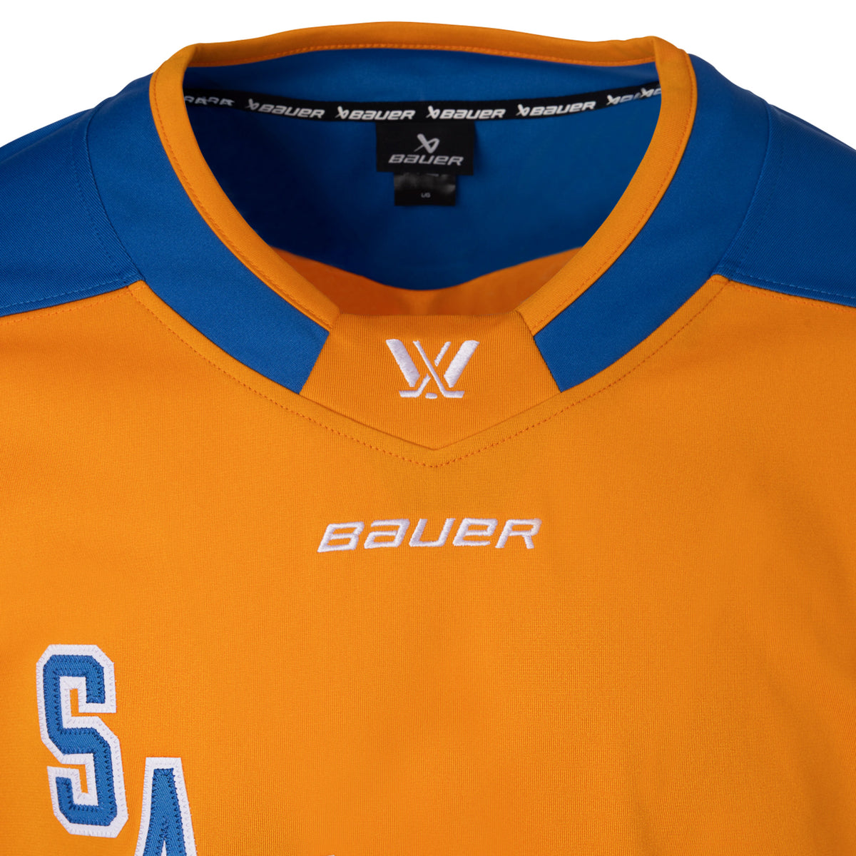 Front of an orange jersey with blue shoulder caps. In blue with white outlining is 'SAN JOSE' diagonally across the chest. The collar is blue with orange trim and color blocking on the front to showcase a white PWHL logo and a white Bauer logo below it. 
