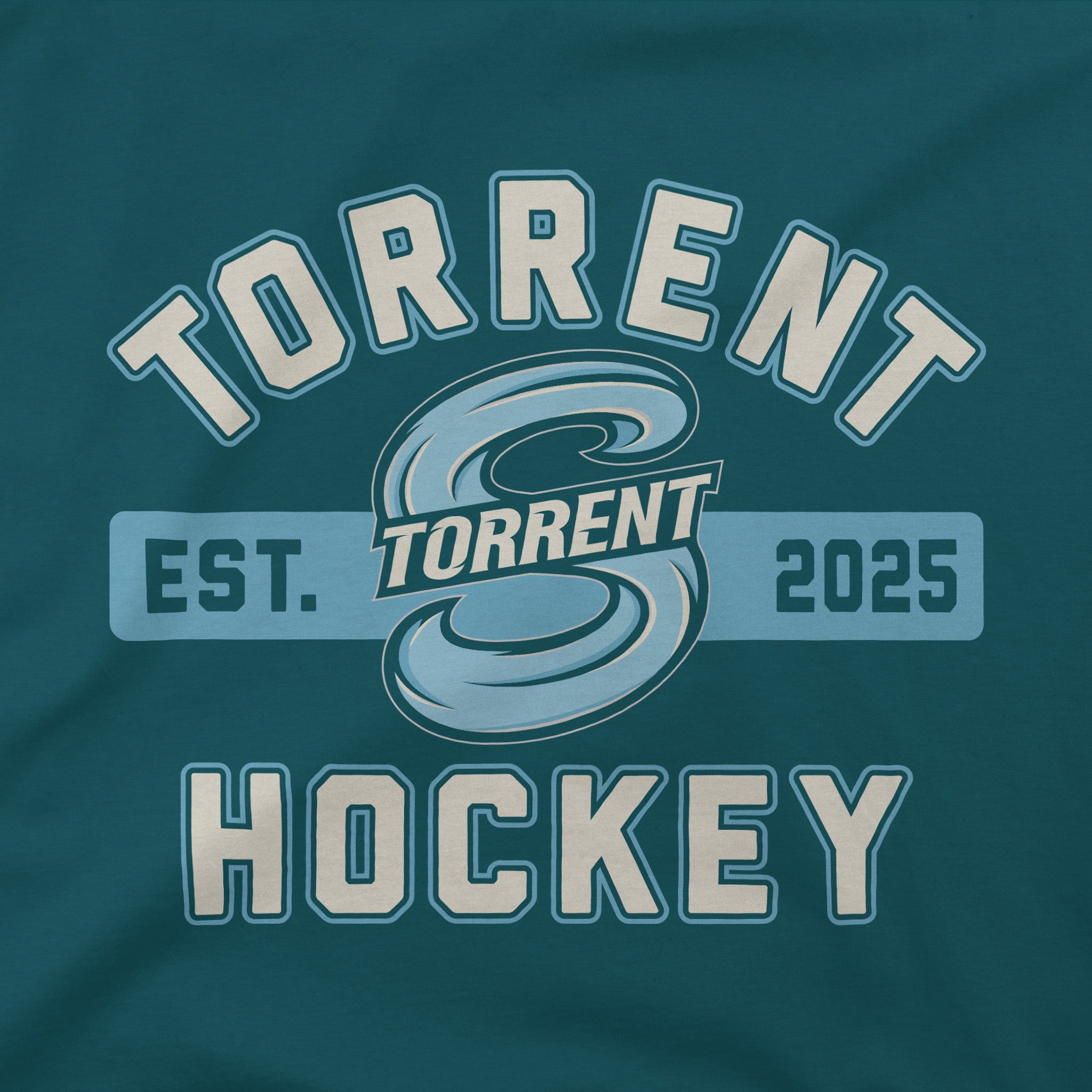 A close-up of a dark teal graphic print on fabric, featuring the words 'TORRENT HOCKEY' in large cream varsity-style letters with a light blue outline, plus a central stylized 'T' logo and 'EST. TORRENT 2025' across the middle.