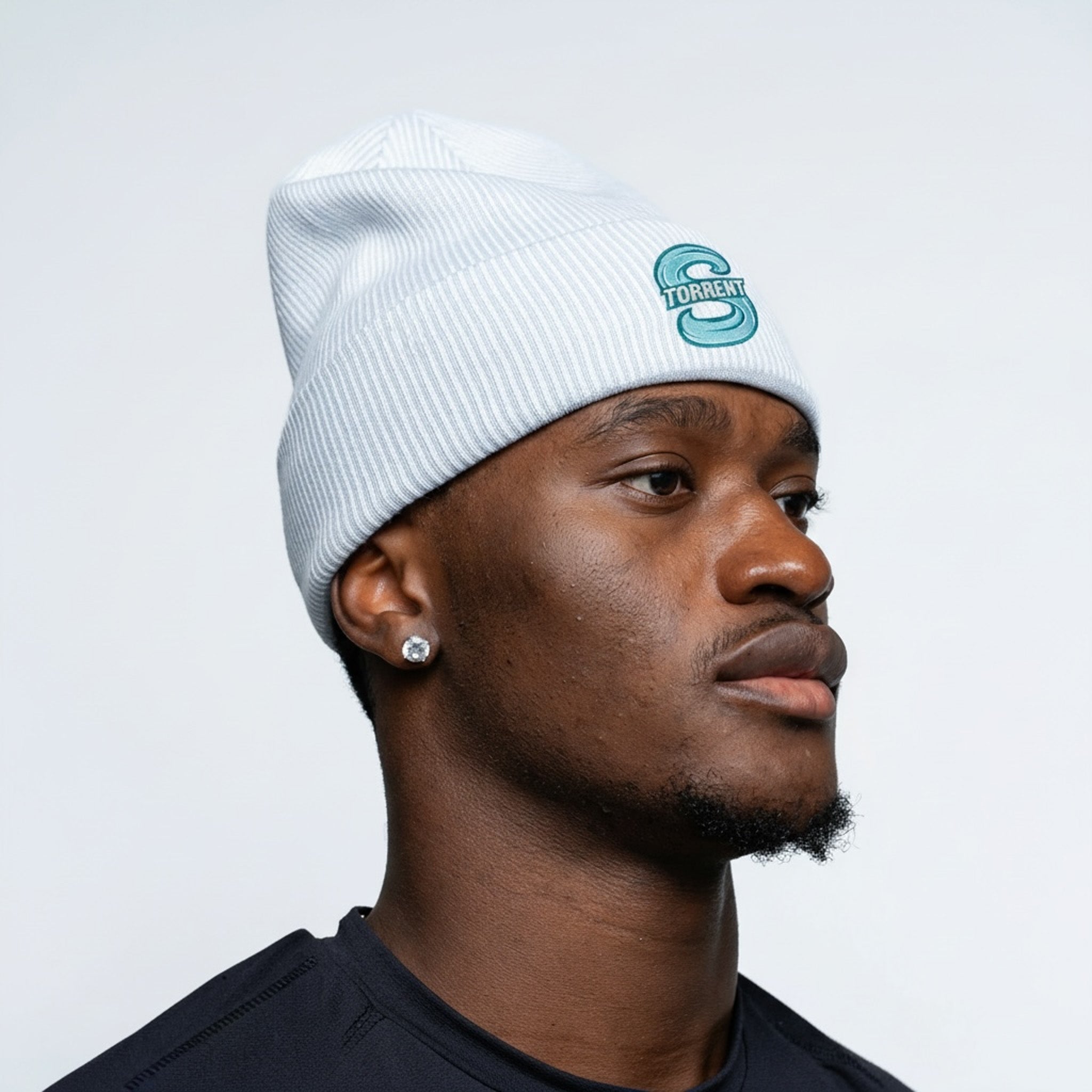 Person wearing a white beanie with a logo on a plain background