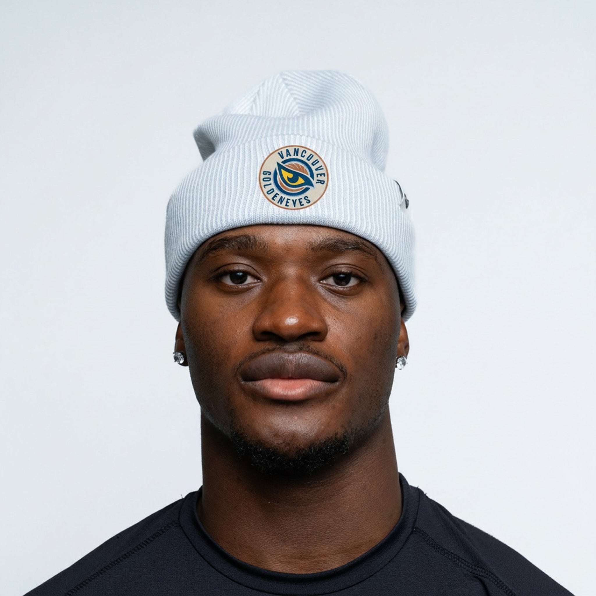Person wearing a white beanie with a logo on a plain background