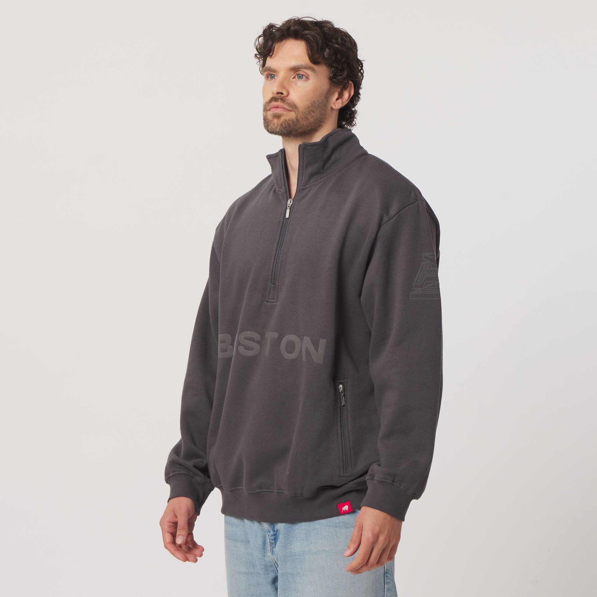 Man wearing a gray half-zip sweatshirt with 'BISTON' branding on a light gray background