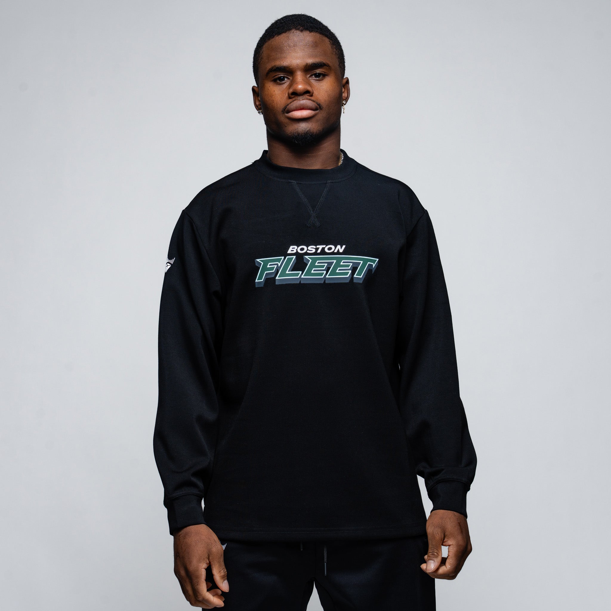 Person wearing a black sweatshirt with 'Boston Fleet' text on a gray background