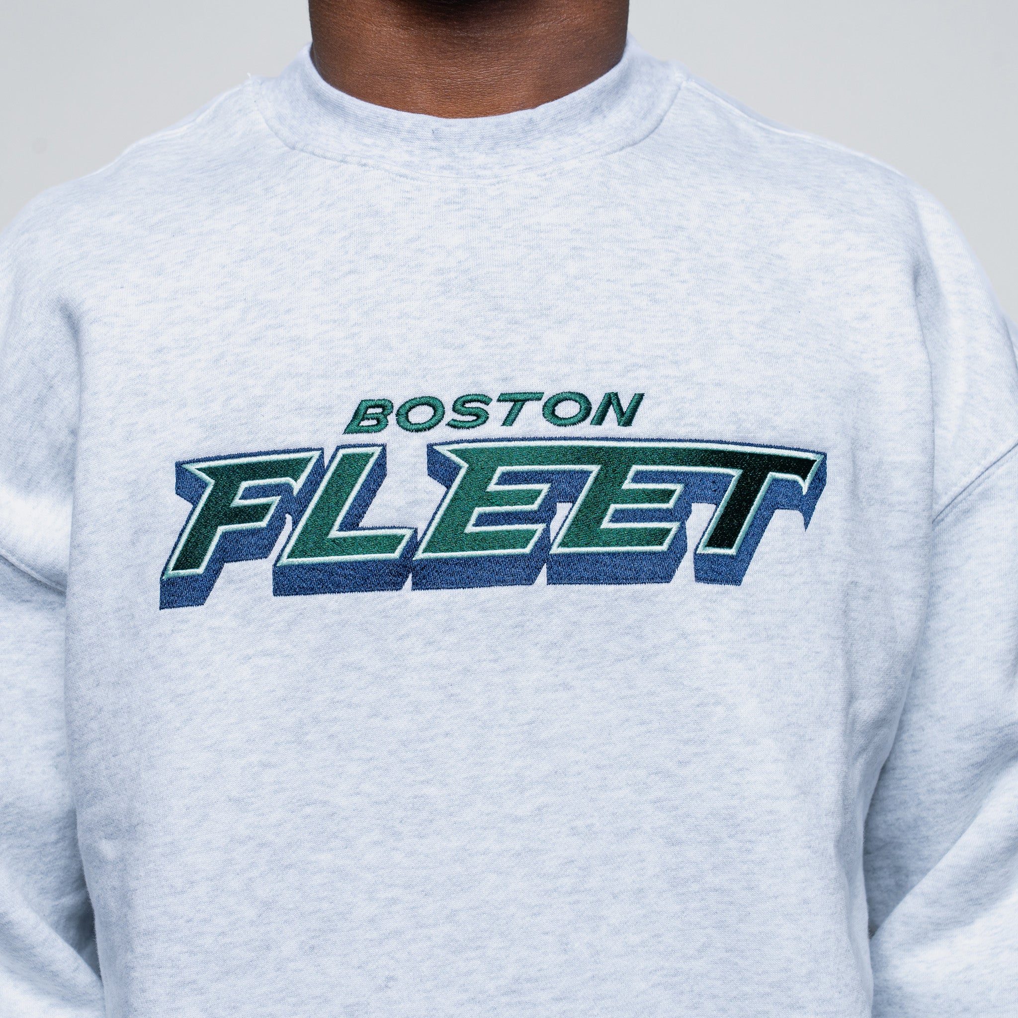 Gray sweatshirt with 'Boston Fleet' text on a plain background