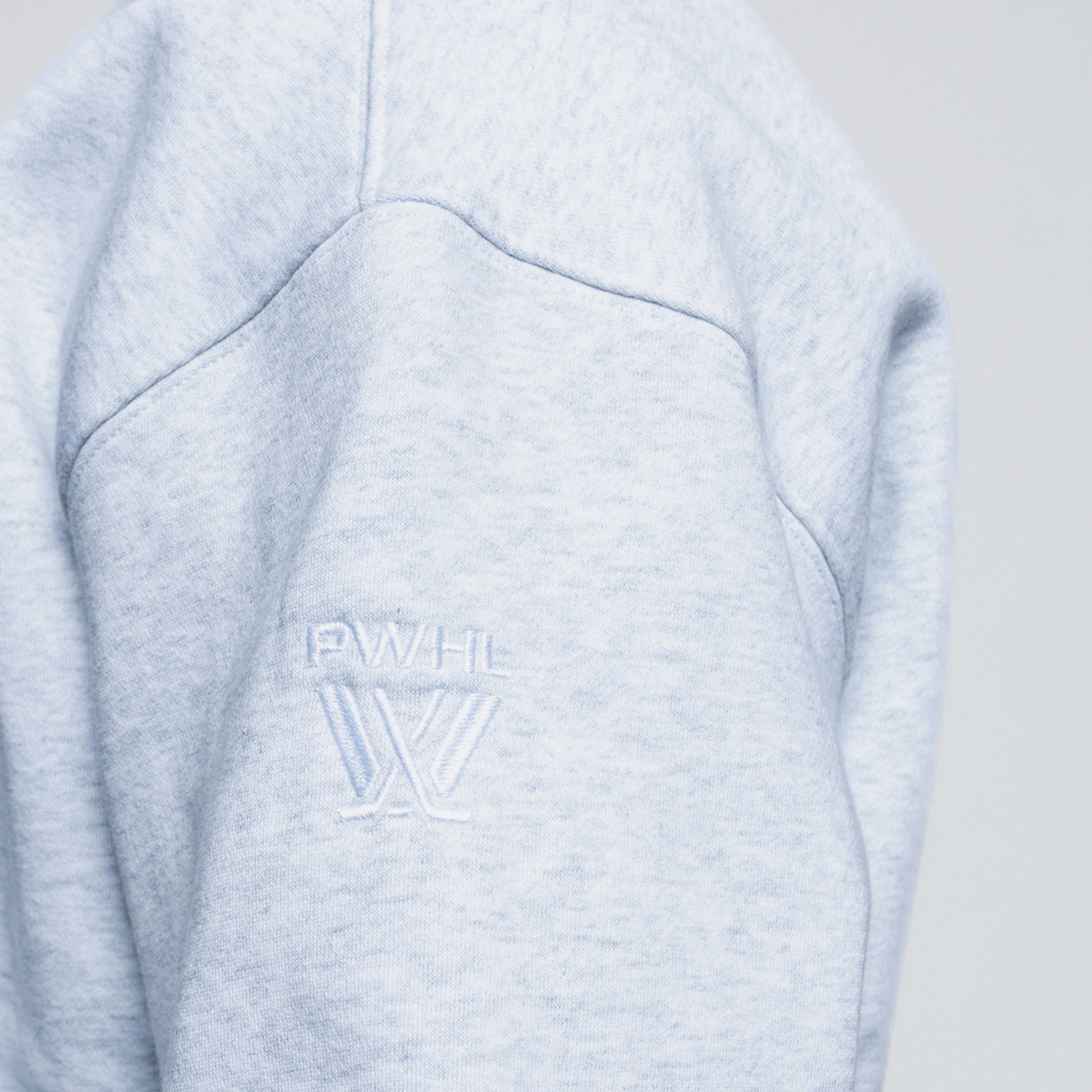 Light gray fleece sweater with a logo on the arm
