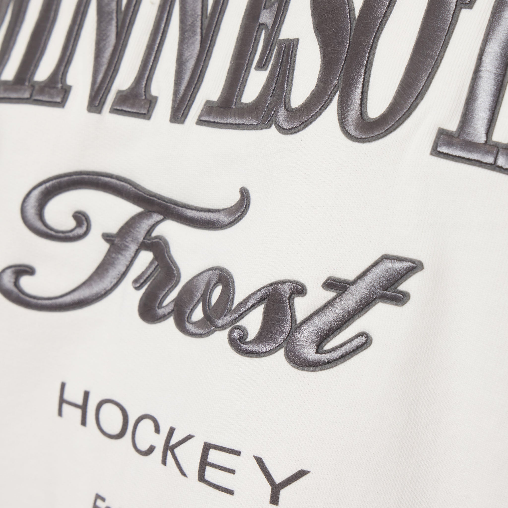 Close-up of a hockey jersey with 'Frost' and 'Hockey' text on a white background