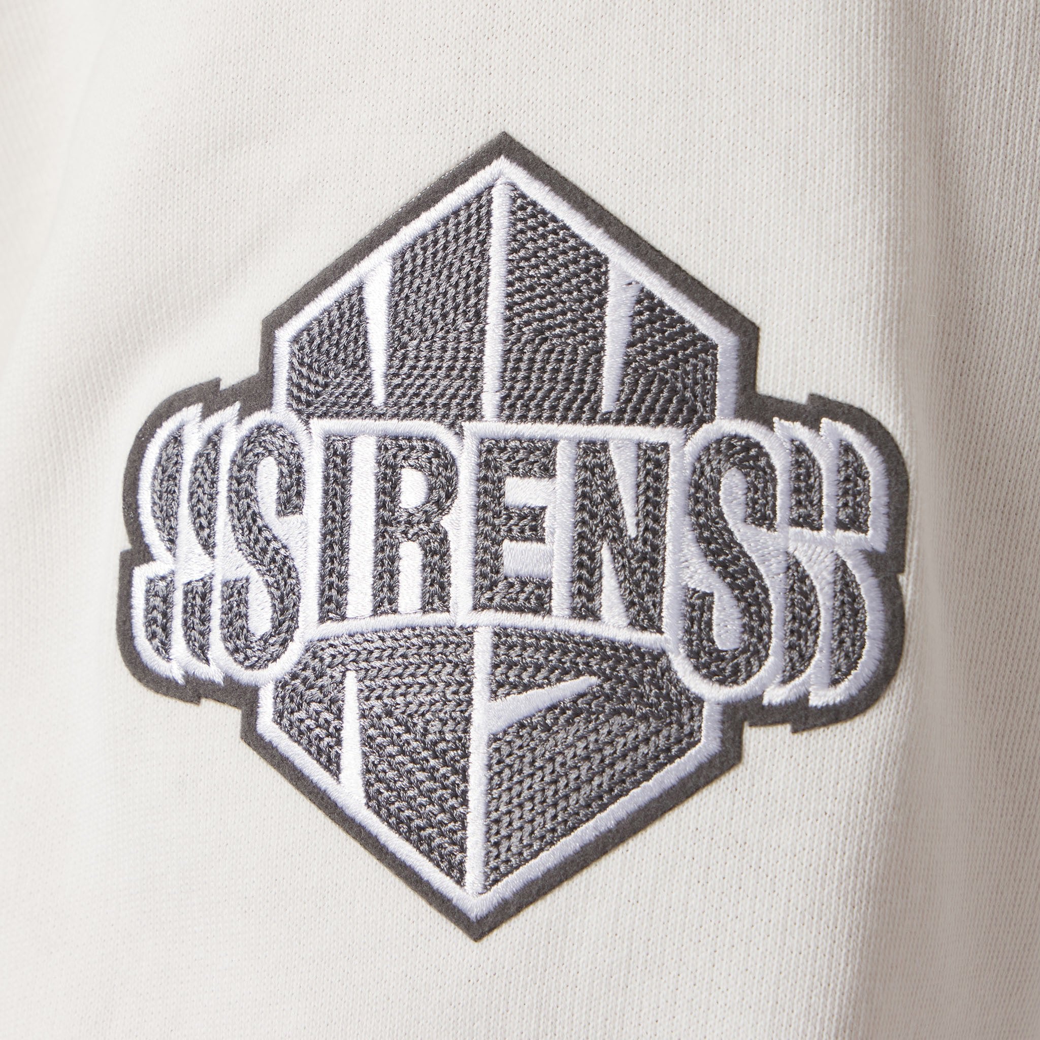 Embroidered logo on a white background