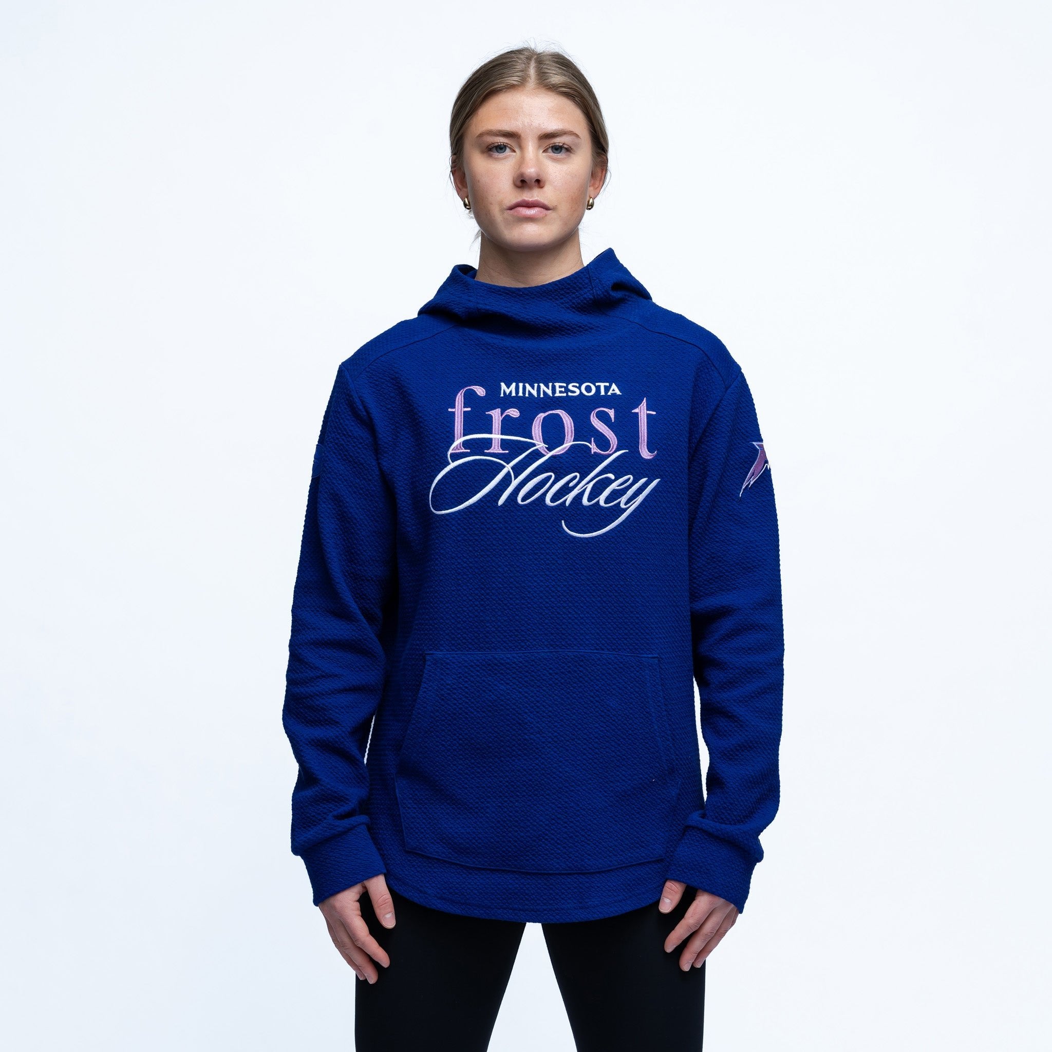 Person wearing a blue hoodie with 'Minnesota Frost Hockey' text on a white background