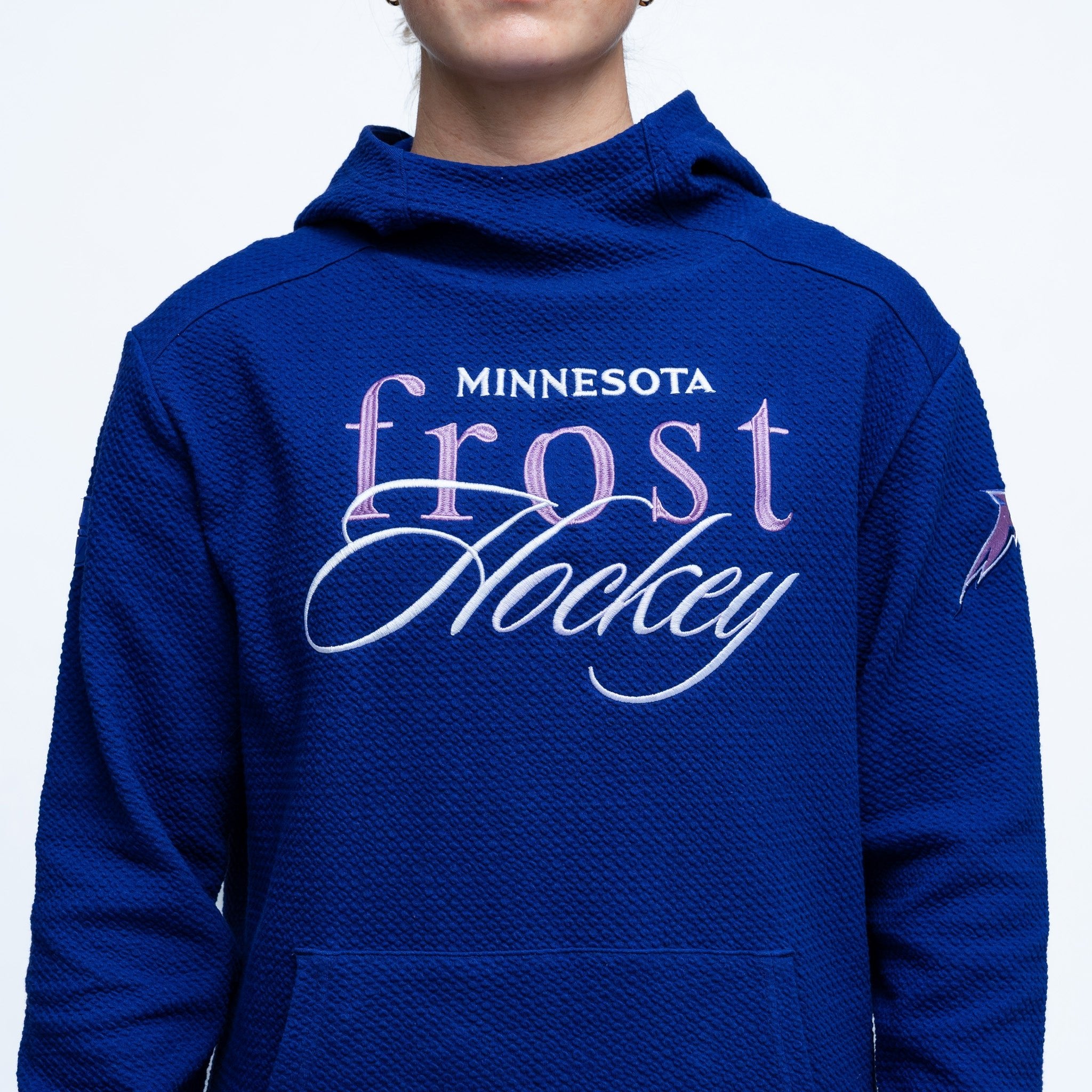 Blue hoodie with 'Minnesota Frost Hockey' text on a white background
