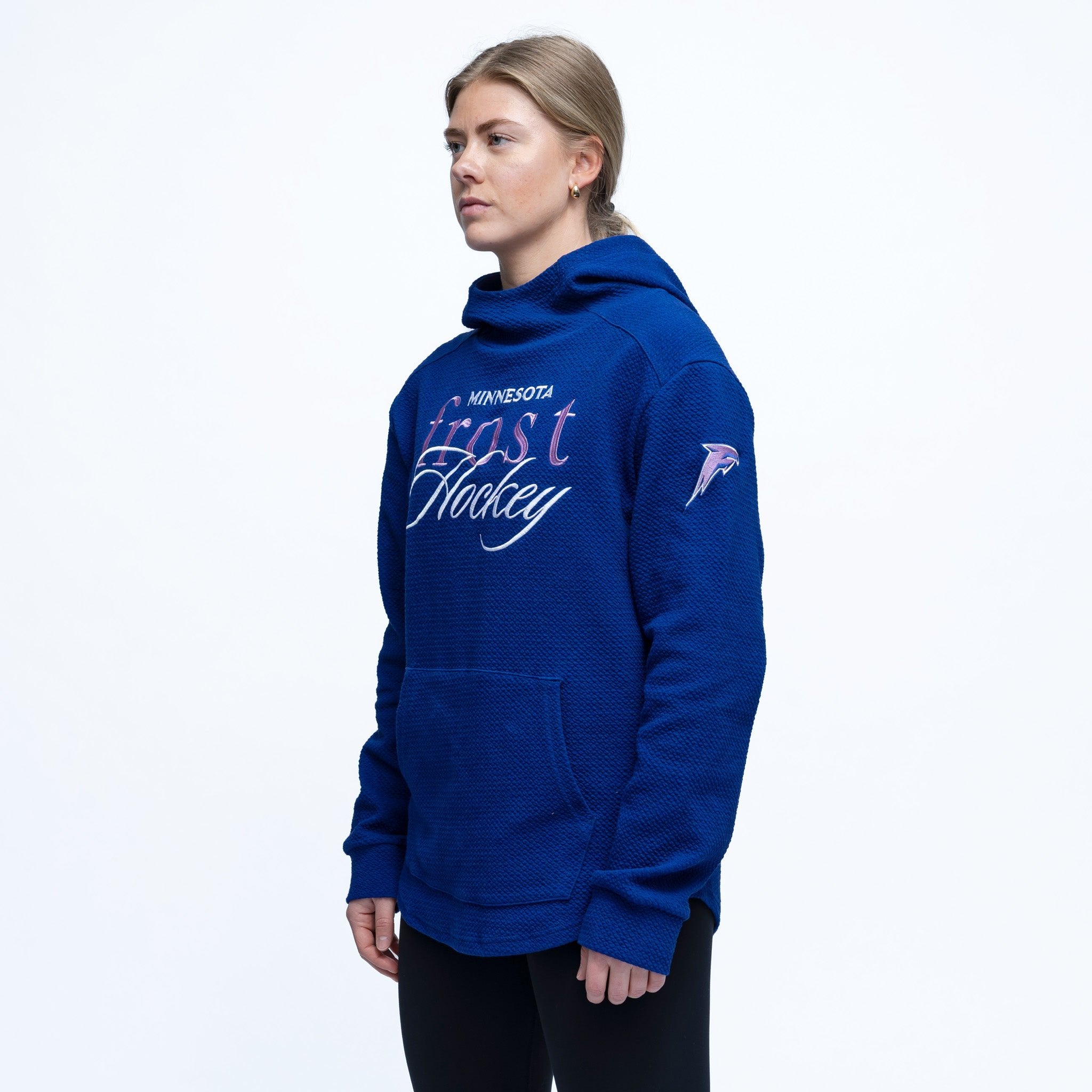 Person wearing a blue hoodie with text and logo on a white background