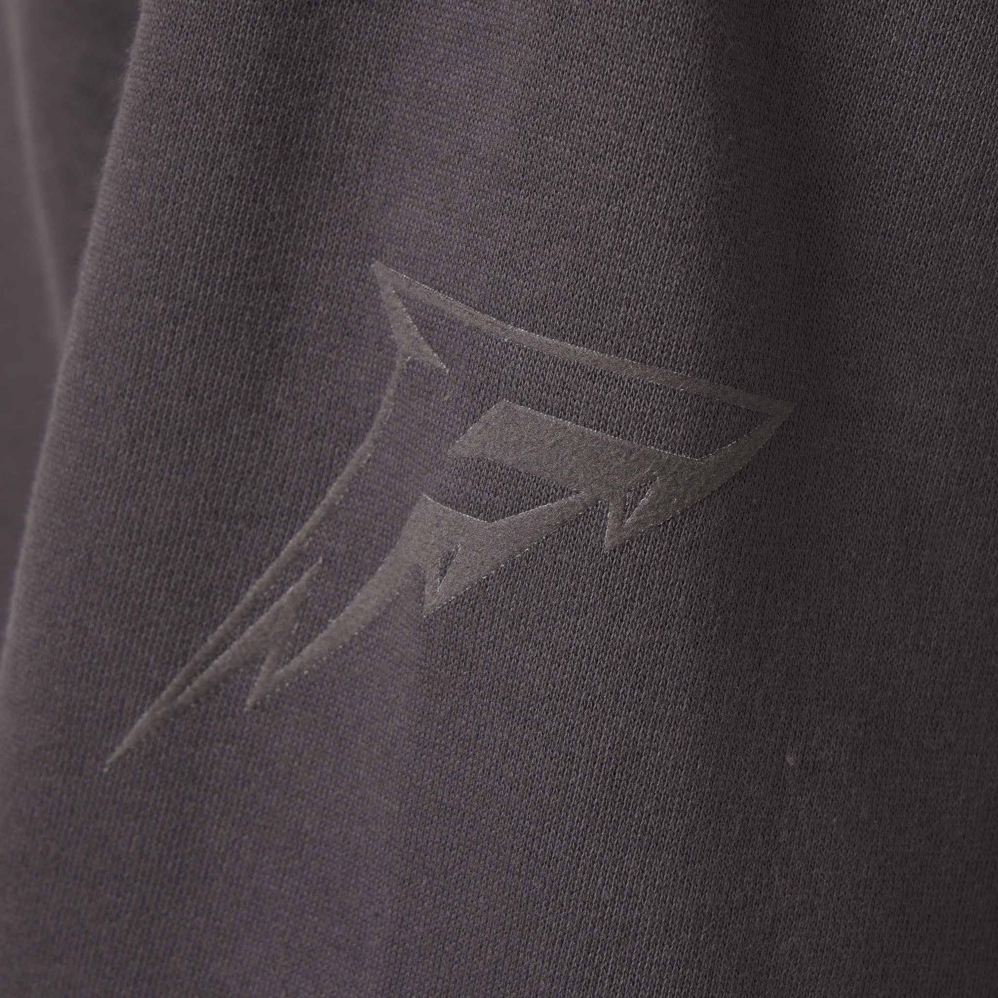 Close-up of a dark gray sweatshirt with a logo on the chest.