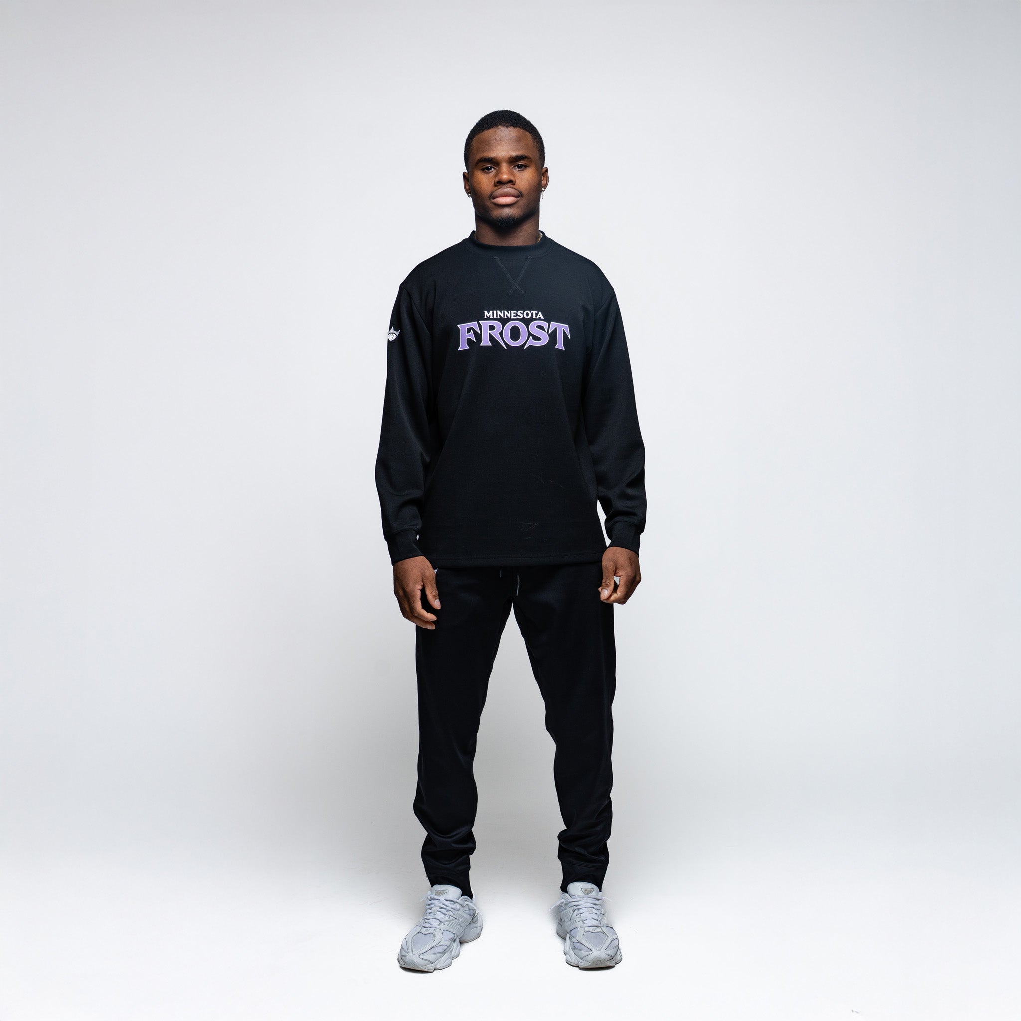 Person wearing a black outfit with 'Frost' branding on a white background