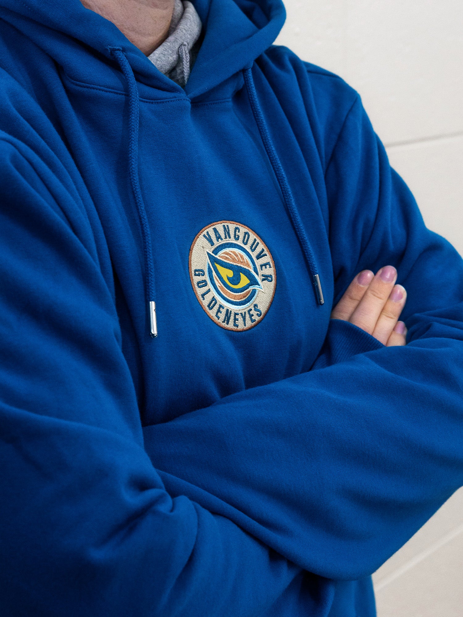Embroidered Vancouver Goldeneyes logo on a blue hoodie