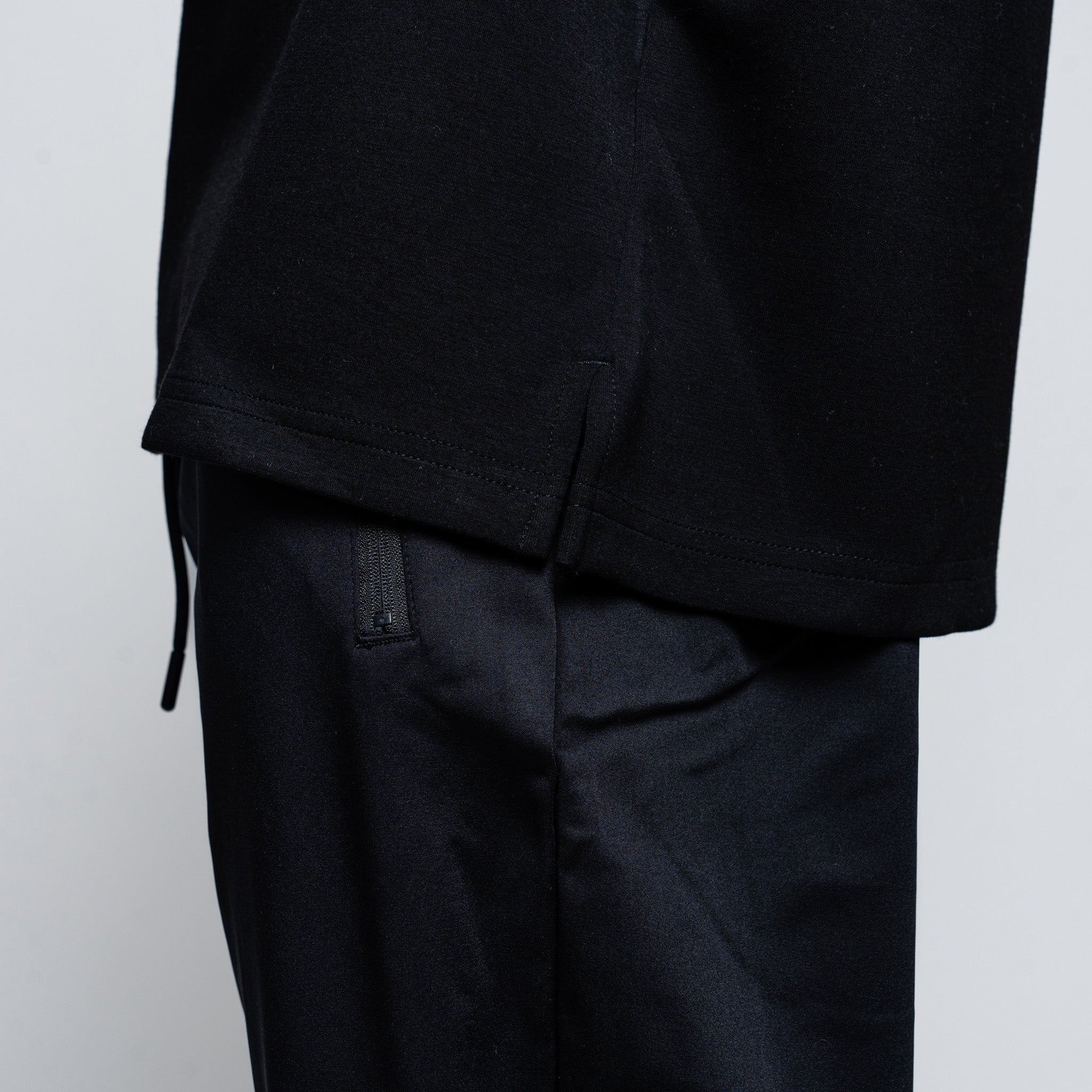 Black sweater and pants on a plain background