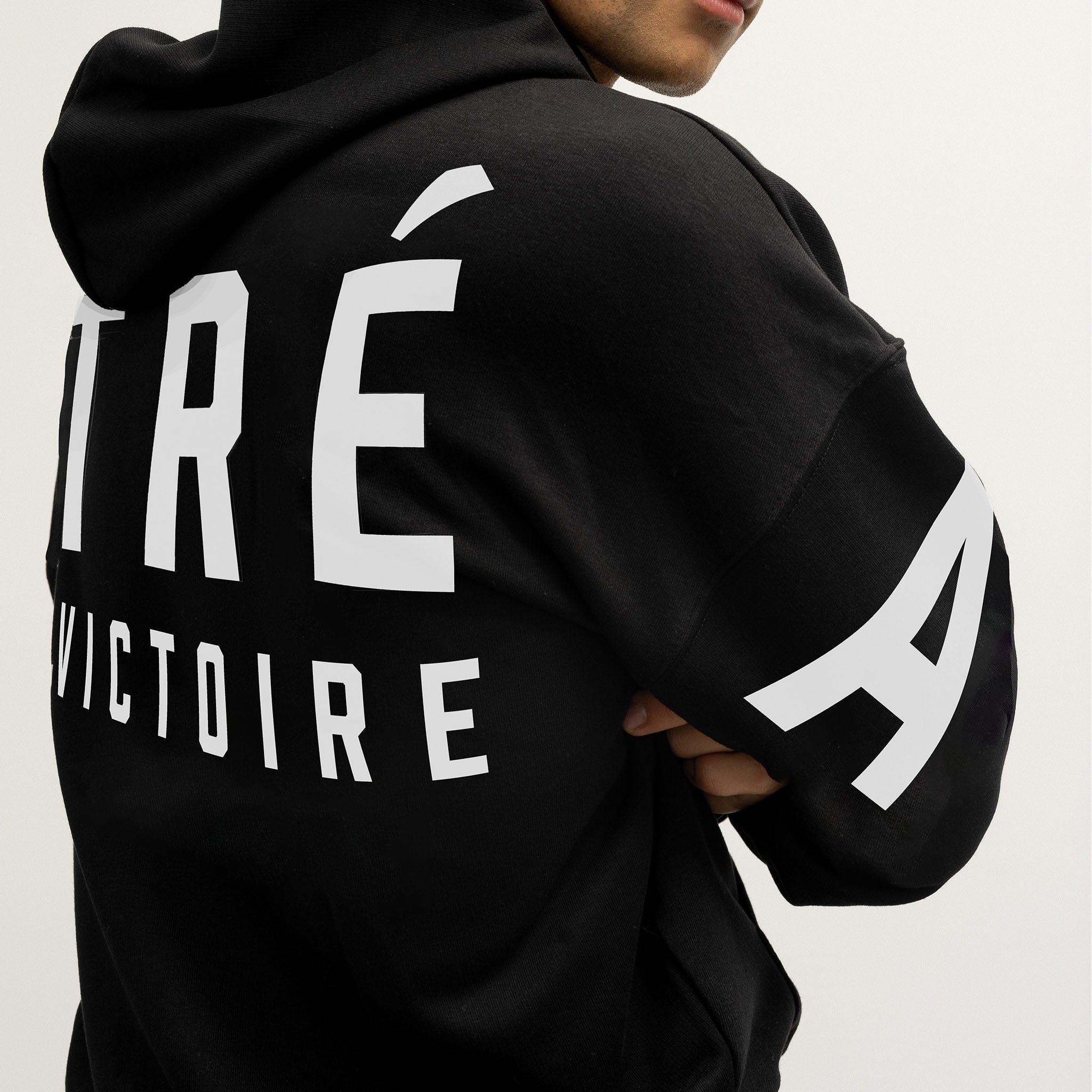 Black hoodie with white Montreal Victoire text and stripes on a plain background