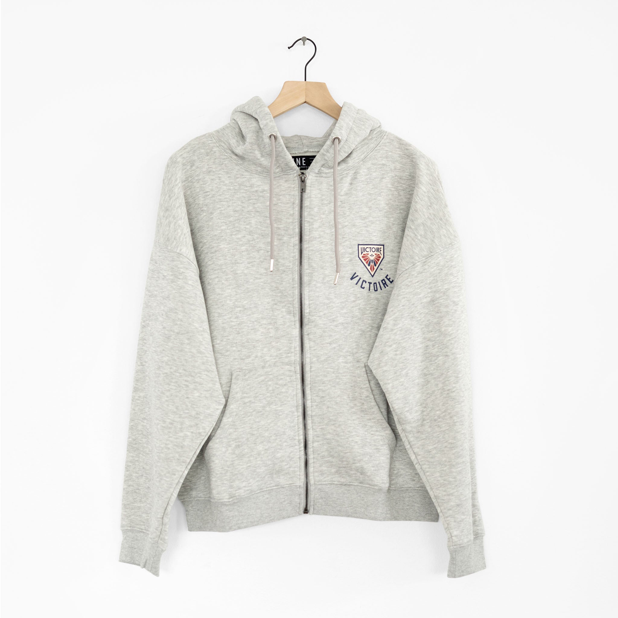 Montreal Victoire graphic design on the back of a grey zip-up hoodie