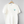 New York Sirens T-shirt – White base with teal and black print, side view highlighting oversized fit and sleeve detail