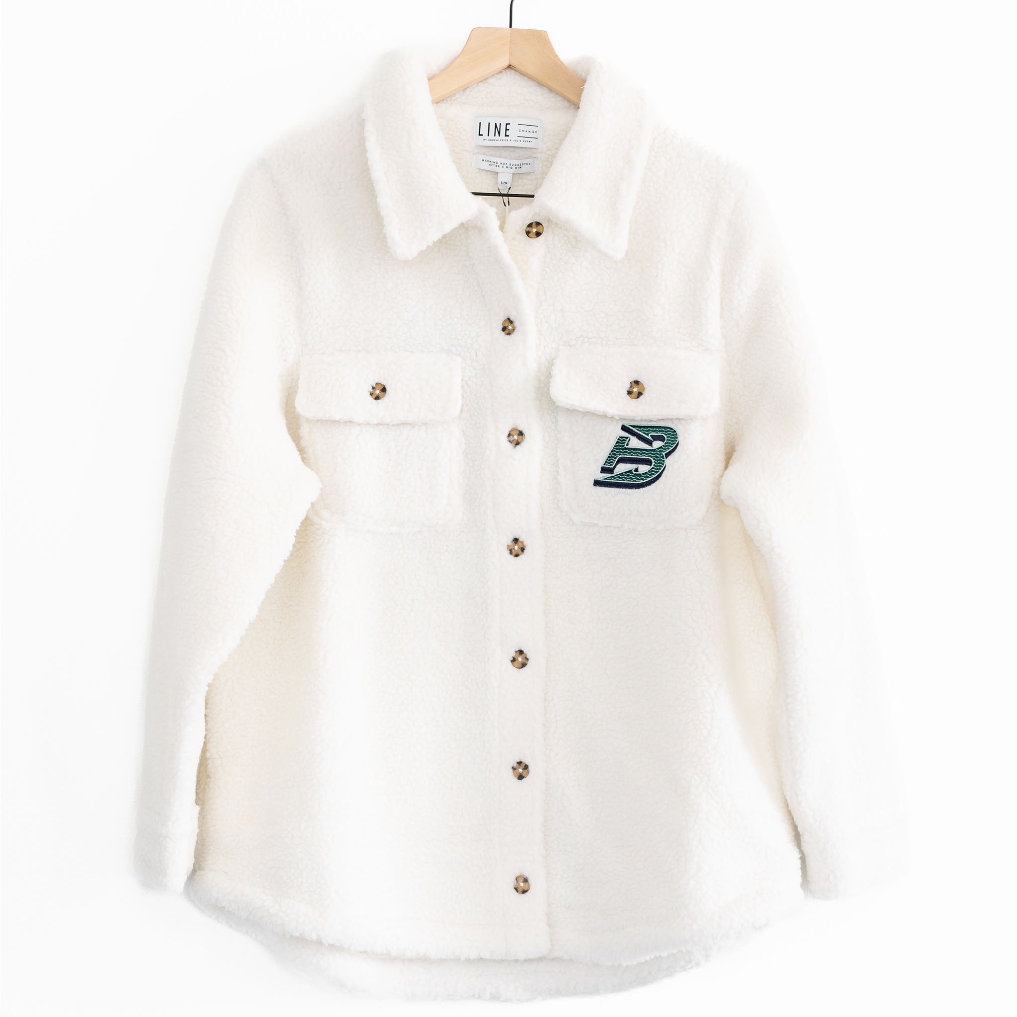 The front of a white sherpa jacket with the Boston Fleet logo on the pocket