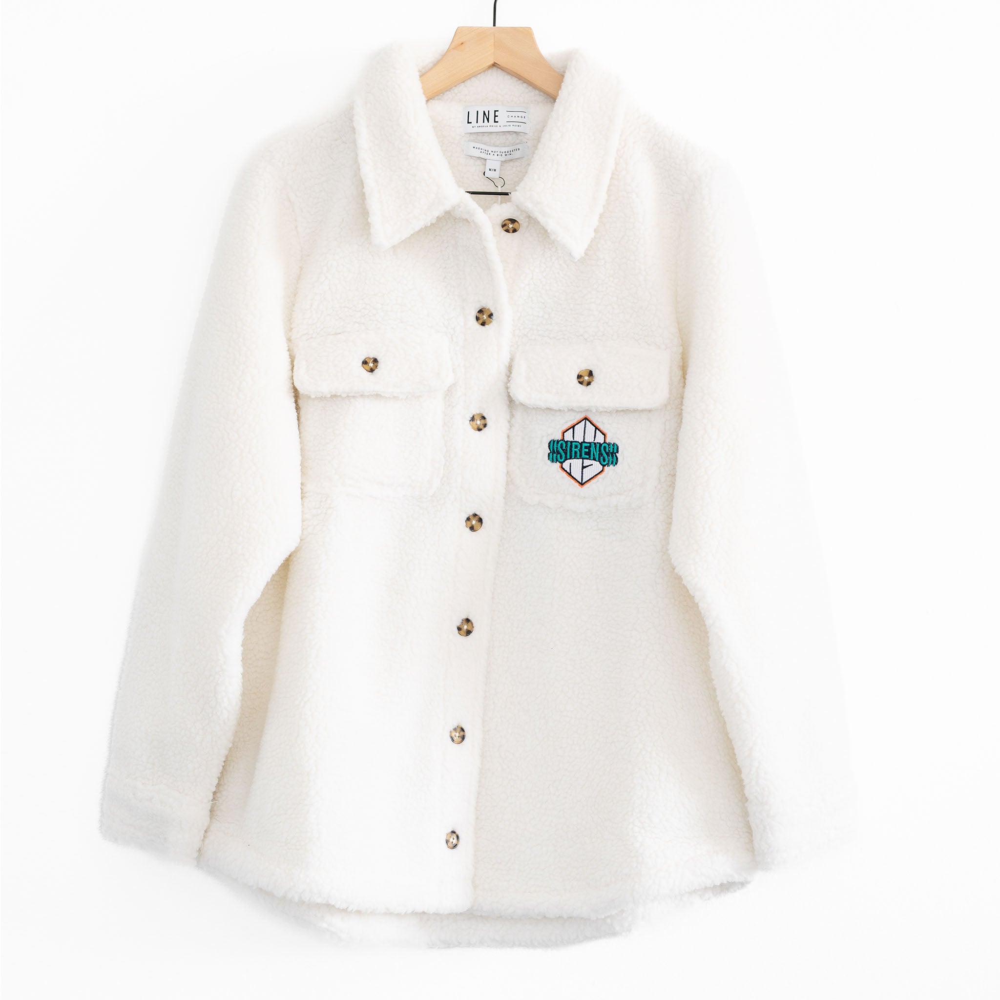 The front of a white sherpa jacket with the Ottawa Charge logo on the pocket