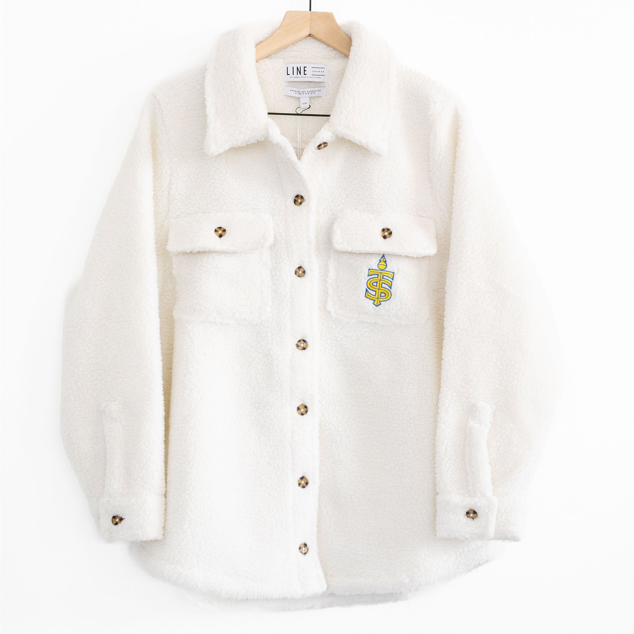 The front of a white sherpa jacket with the Toronto Sceptres logo on the pocket