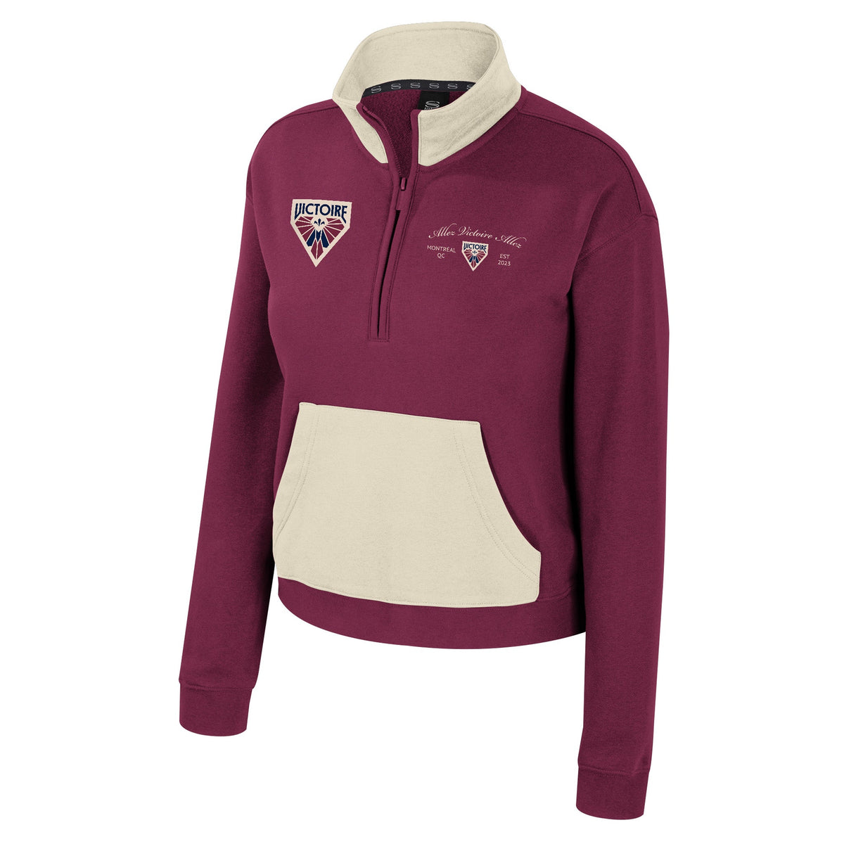 The front of a burgundy fleece half zip with cream color blocking on collar and front pocket. The right chest has an embroidered Montreal Victoire logo. The left chest has ‘Alles Victoire Allez’ embroidered in cursive above a small, embroidered Montreal Victoire Logo with ‘MONTREAL, QB’ and ‘EST 2023’ on each side of it.