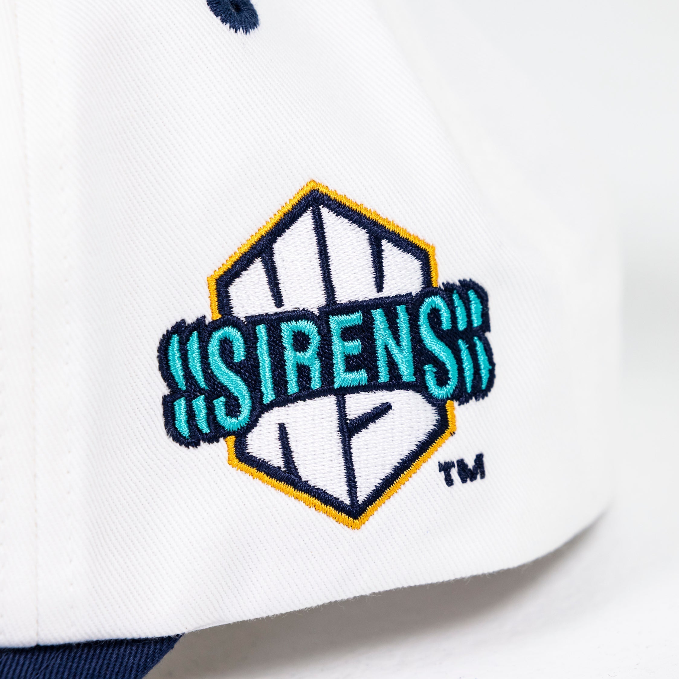 Close-up of a cap with 'Sirens' logo on a white background