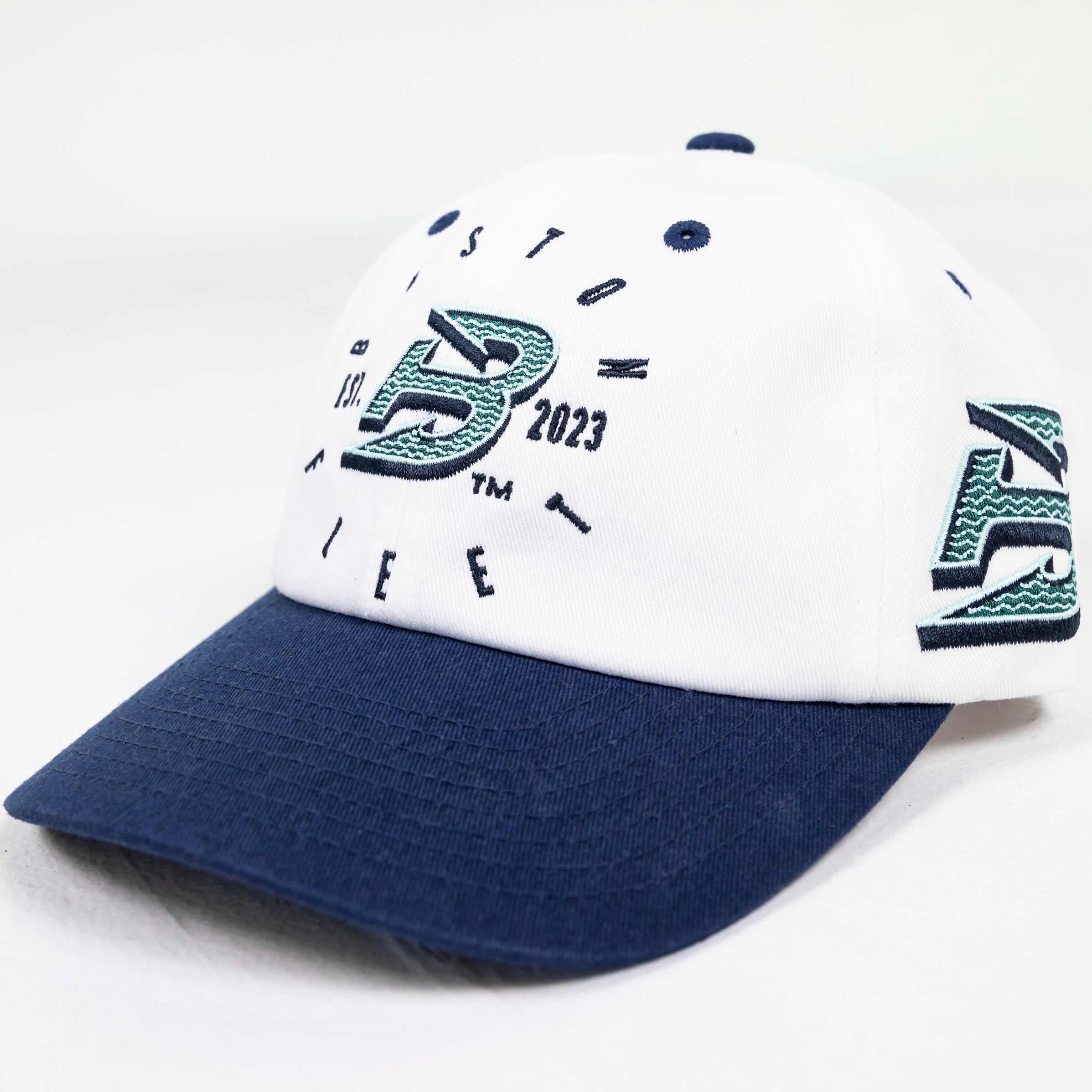 White cap with blue brim and branding on a white background