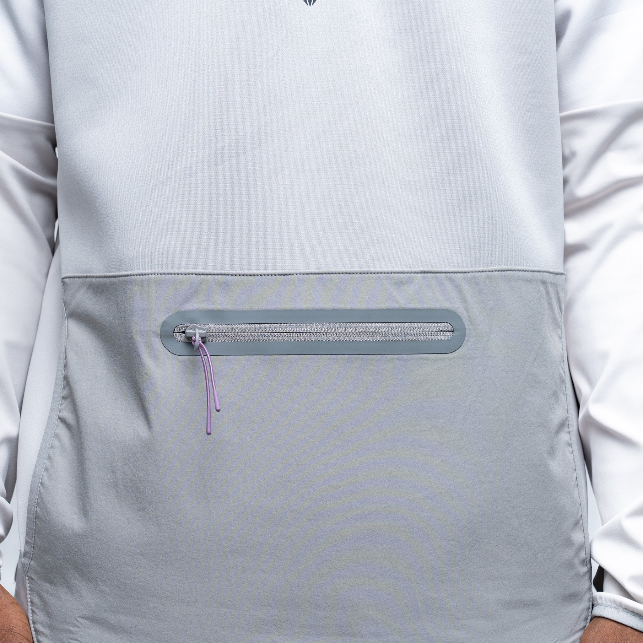 Close-up of a gray jacket with a zipper pocket on a white background