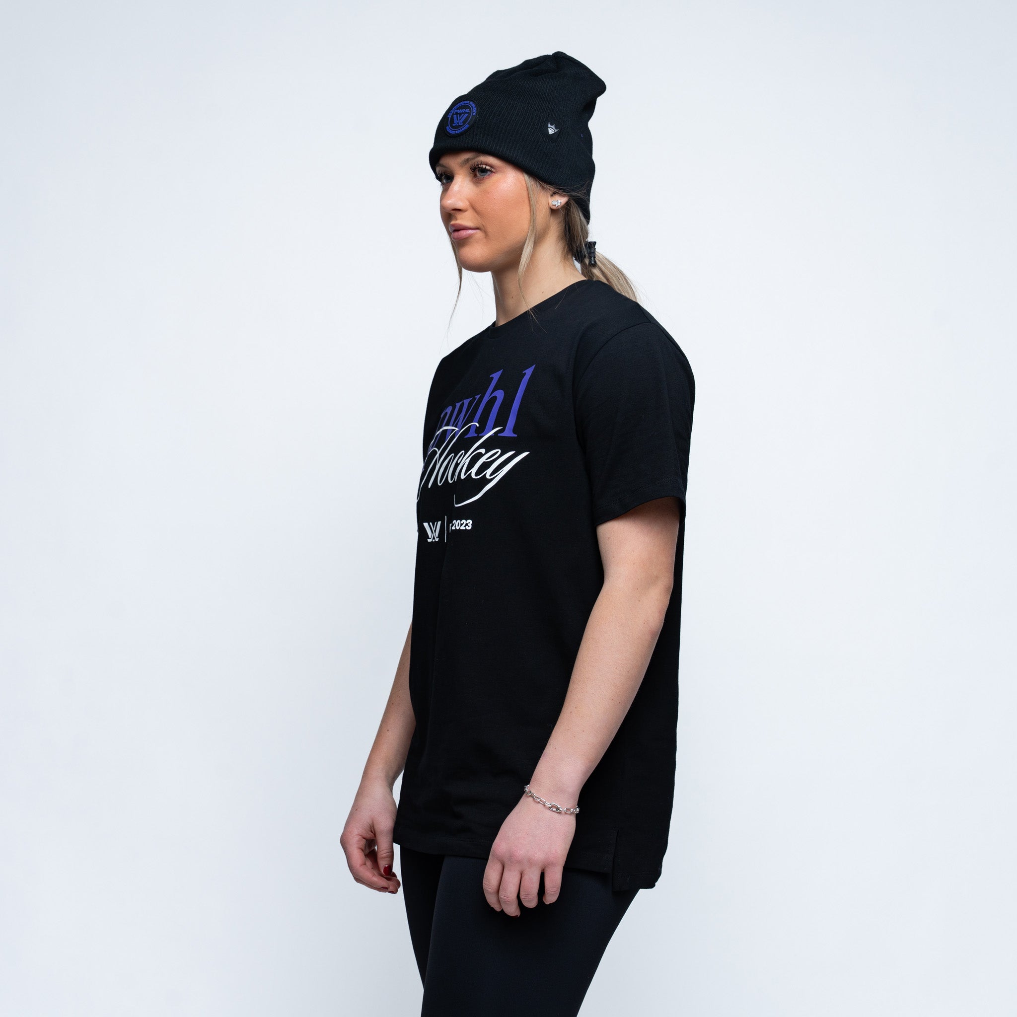 side angle of a person wearing a black tshirt and pwhl text