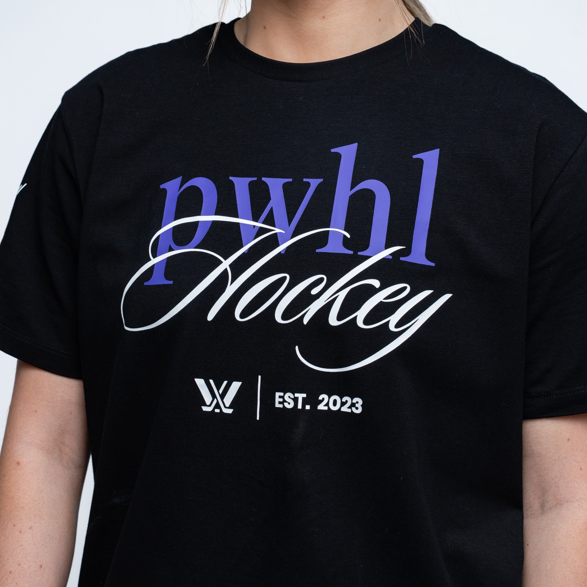 close up of a black tshirt with "PWHL Hockey" text, the PWHL logo, and EST. 2023 graphic