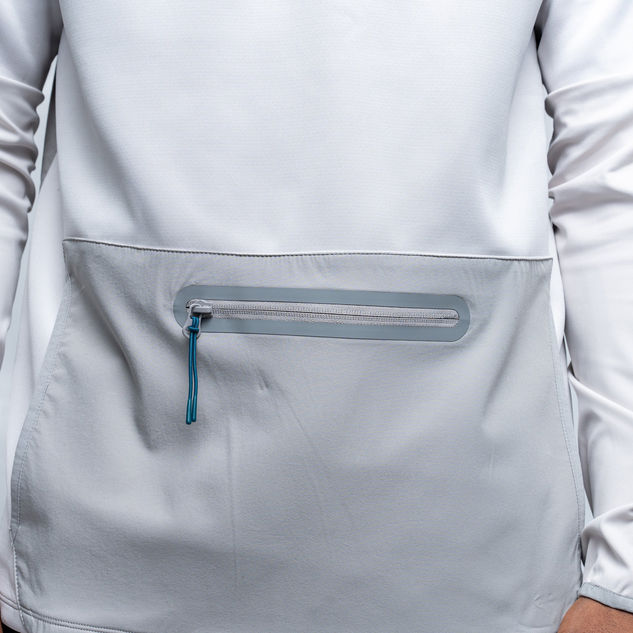 Close-up of a light gray jacket with a zipper pocket on a white background