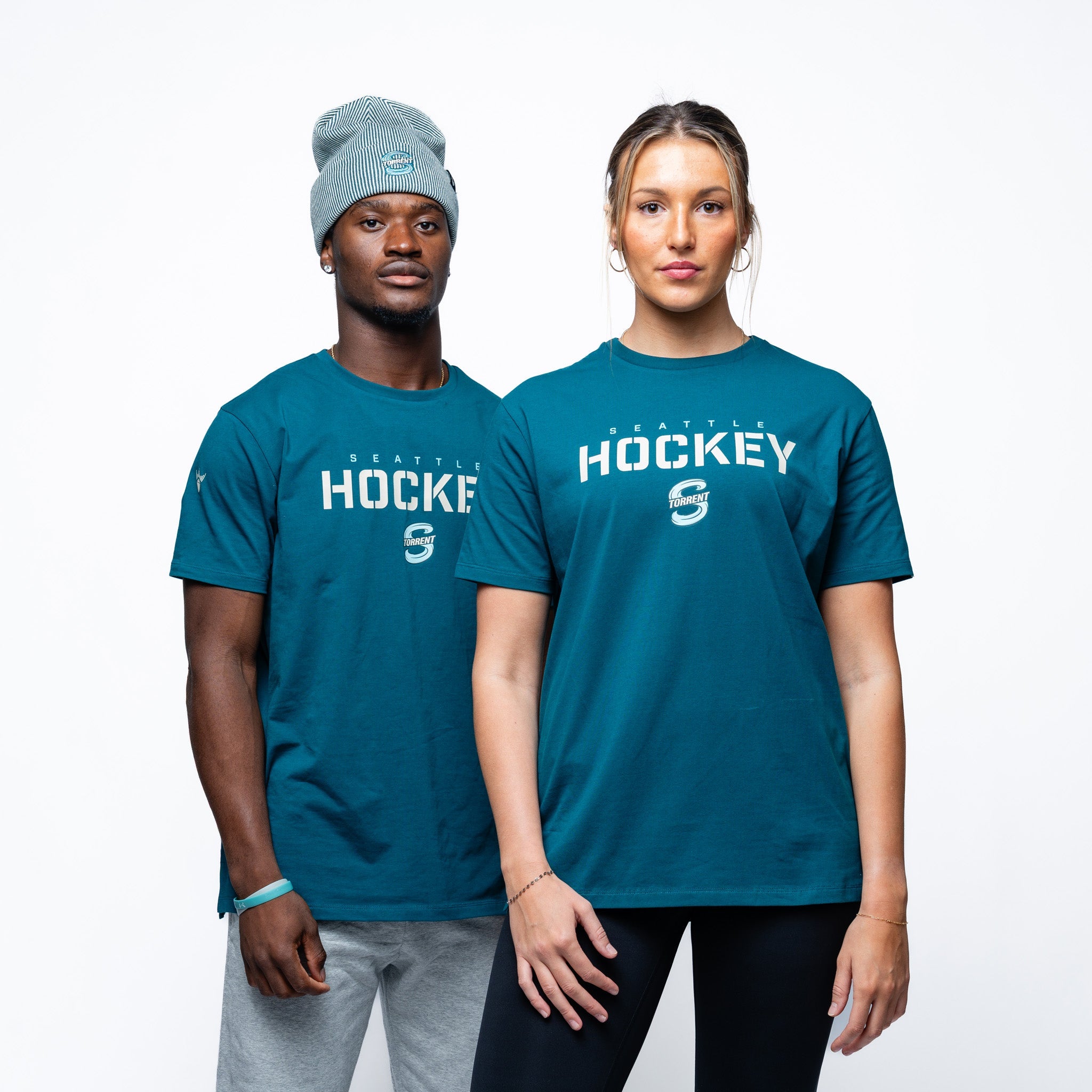 Man and woman wearing green Adult Seattle Torrent Royalty Essential Sideline T-Shirt front angle