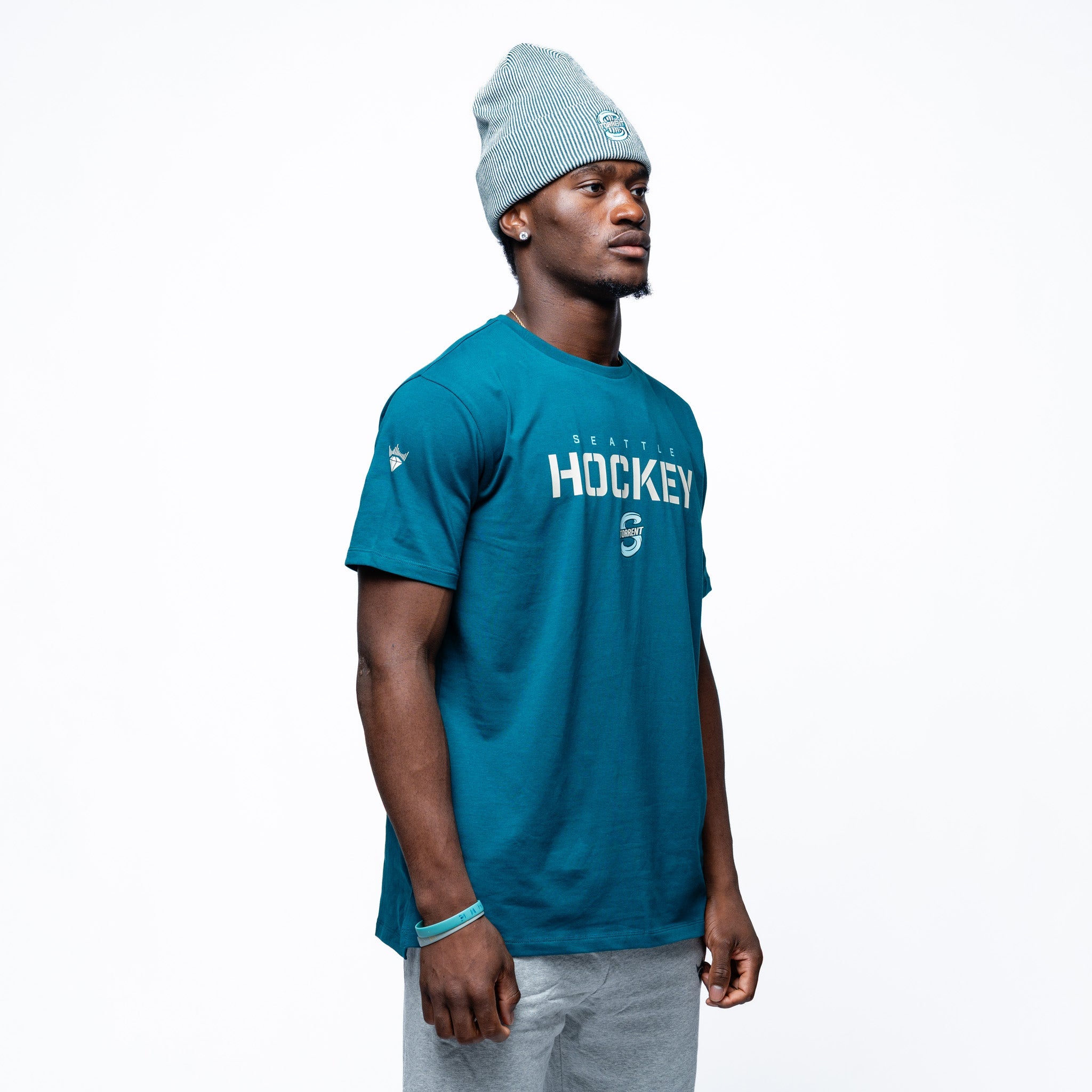 Person wearing green Adult Seattle Torrent Royalty Essential Sideline T-Shirt side angle