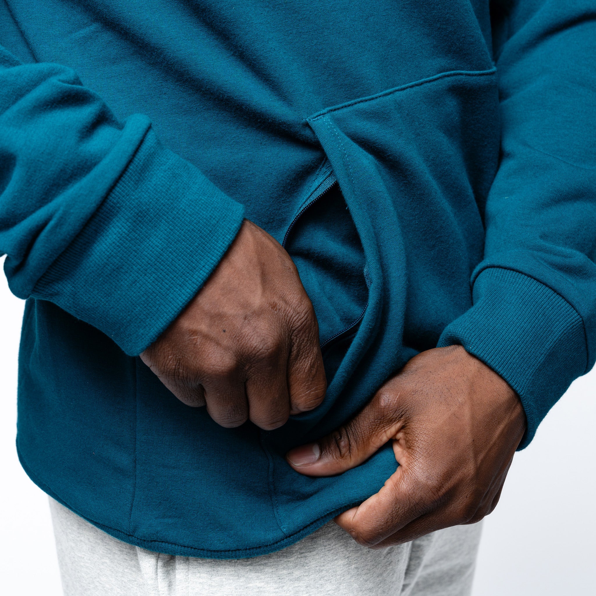 close up of the zippered pocket on the green Adult Seattle Torrent Royalty Heritage Cloud Hoodie