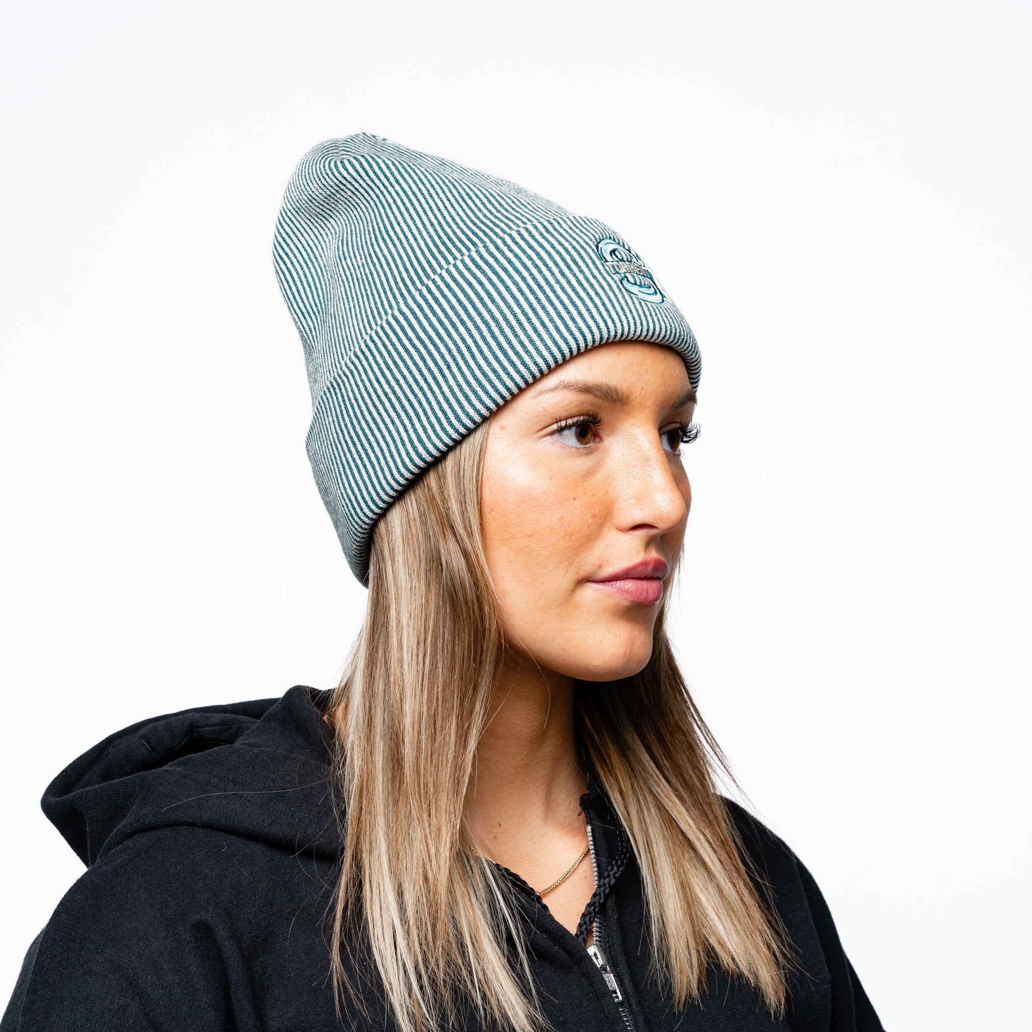 Side angle of a woman wearing the green Adult Seattle Torrent Royalty Double Knit Beanie