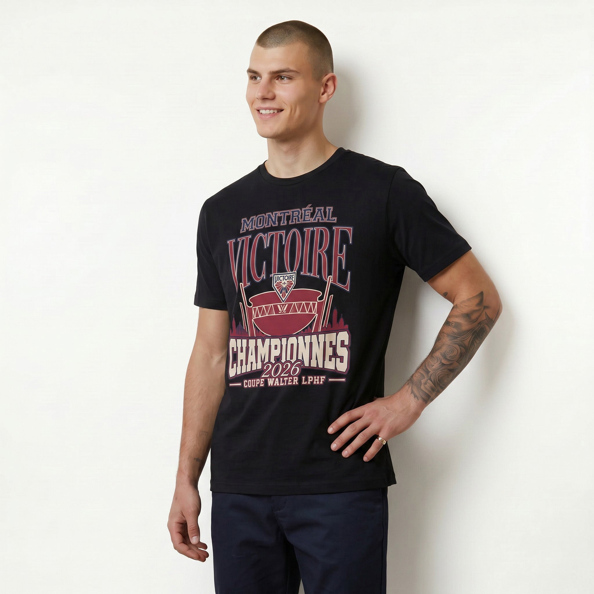 Man wearing a black t-shirt with red and white text and graphics on a white background